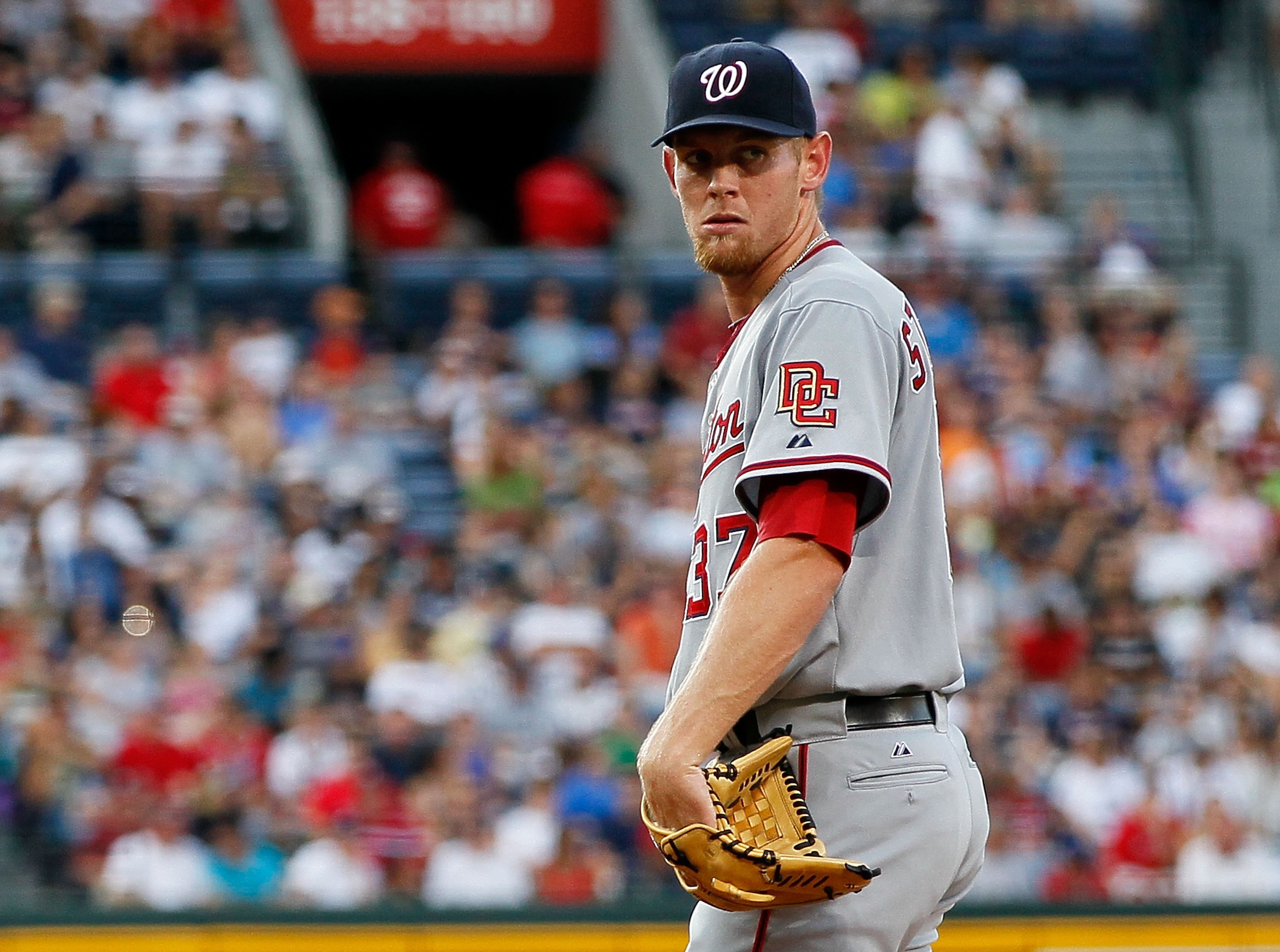 ATLANTA - JUNE 28:  Starting pitcher Stephen Strasburg #37 of the Washington Nationals checks the runner on first base in the second inning against the Atlanta Braves at Turner Field on June 28, 2010 in Atlanta, Georgia.  (Photo by Kevin C. Cox/Getty Imag