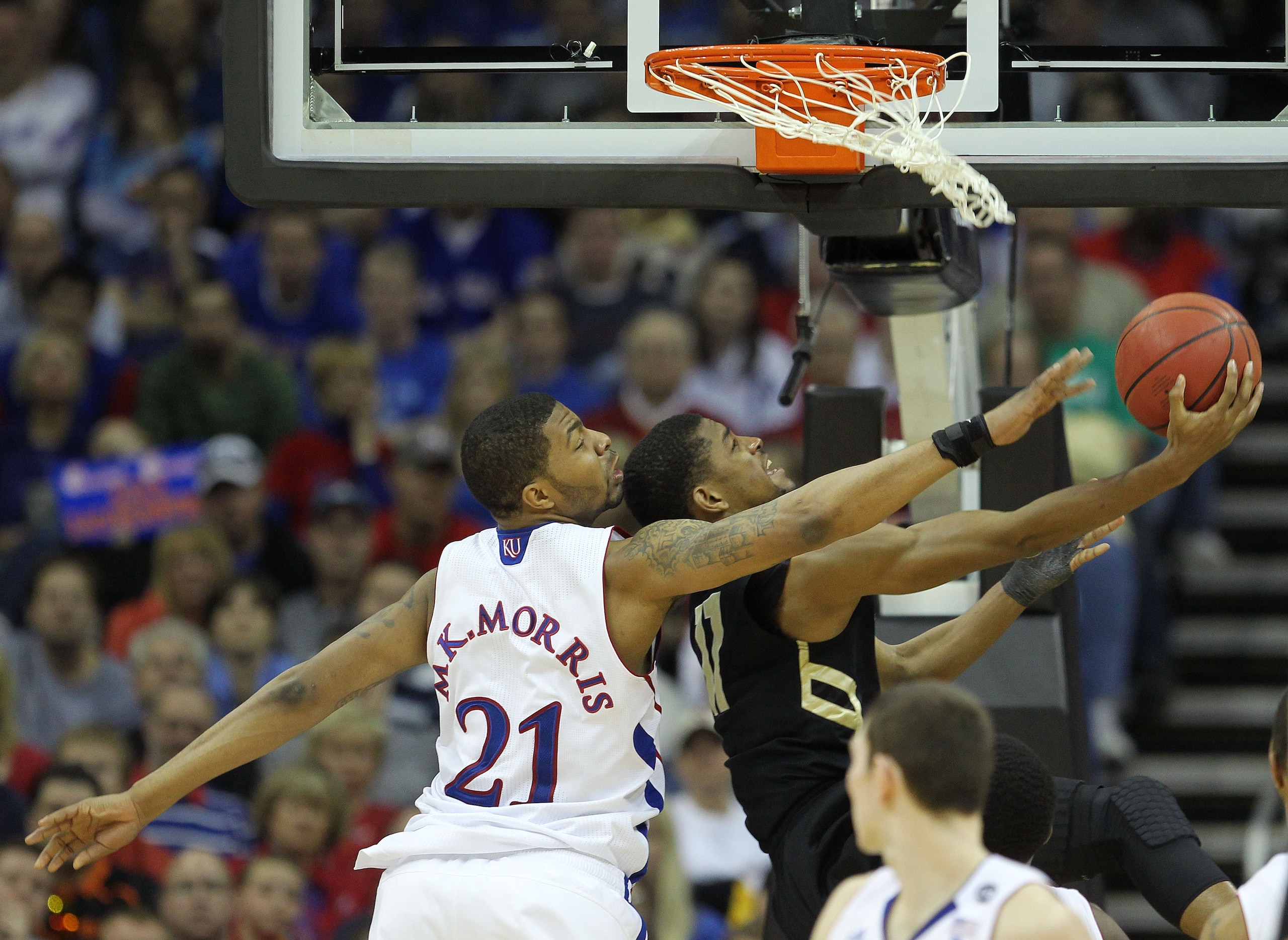 KANSAS CITY, MO - MARCH 11: Cory Higgins #11 of the Colorado Buffaloes looks to score as Markieff Morris #21 of the Kansas Jayhawks defends during their semifinal game in the 2011 Phillips 66 Big 12 Men's Basketball Tournament at Sprint Center on March 1 KANSAS CITY, MO - MARCH 11: Cory Higgins #11 of the Colorado Buffaloes looks to score as Markieff Morris #21 of the Kansas Jayhawks defends during their semifinal game in the 2011 Phillips 66 Big 12 Men's Basketball Tournament at Sprint Center on March 1