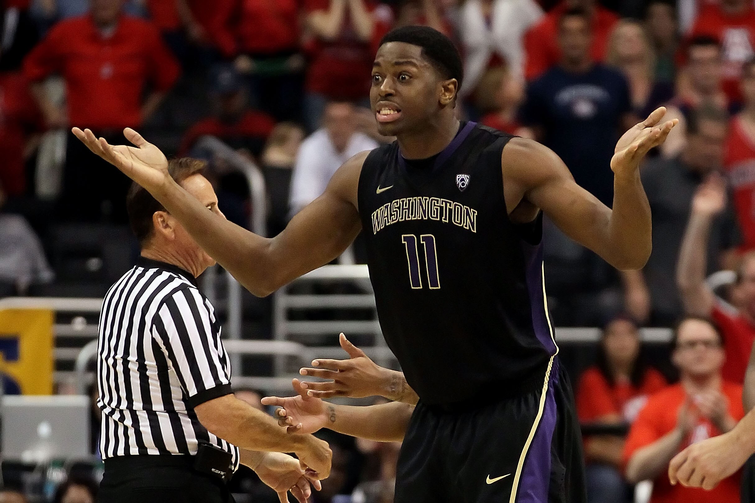 LOS ANGELES, CA - MARCH 12:  Matthew Bryan-Amaning #11 of the Washington Huskies reacts after picking up his fifth foul while taking on the Arizona Wildcats in the championship game of the 2011 Pacific Life Pac-10 Men's Basketball Tournament at Staples Ce