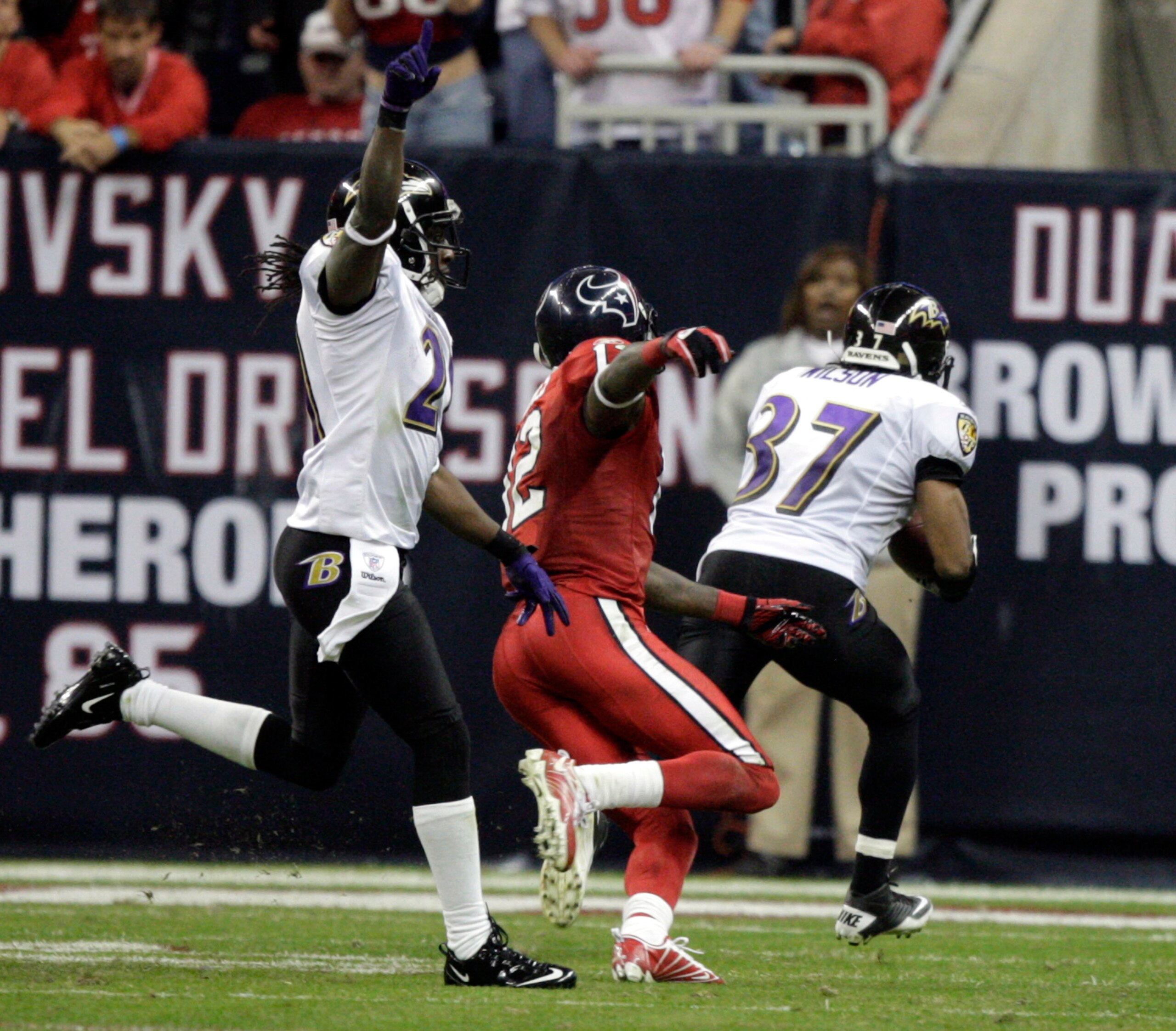 HOUSTON, TX - DECEMBER 13:  Cornerback Josh Wilson #37 of the Baltimore Ravens intercepts Matt Schaub of the Houston Texans for the winning touchdown in overtime as Derrick Ward #32 of the Houston Texans watches at Reliant Stadium on December 13, 2010 in