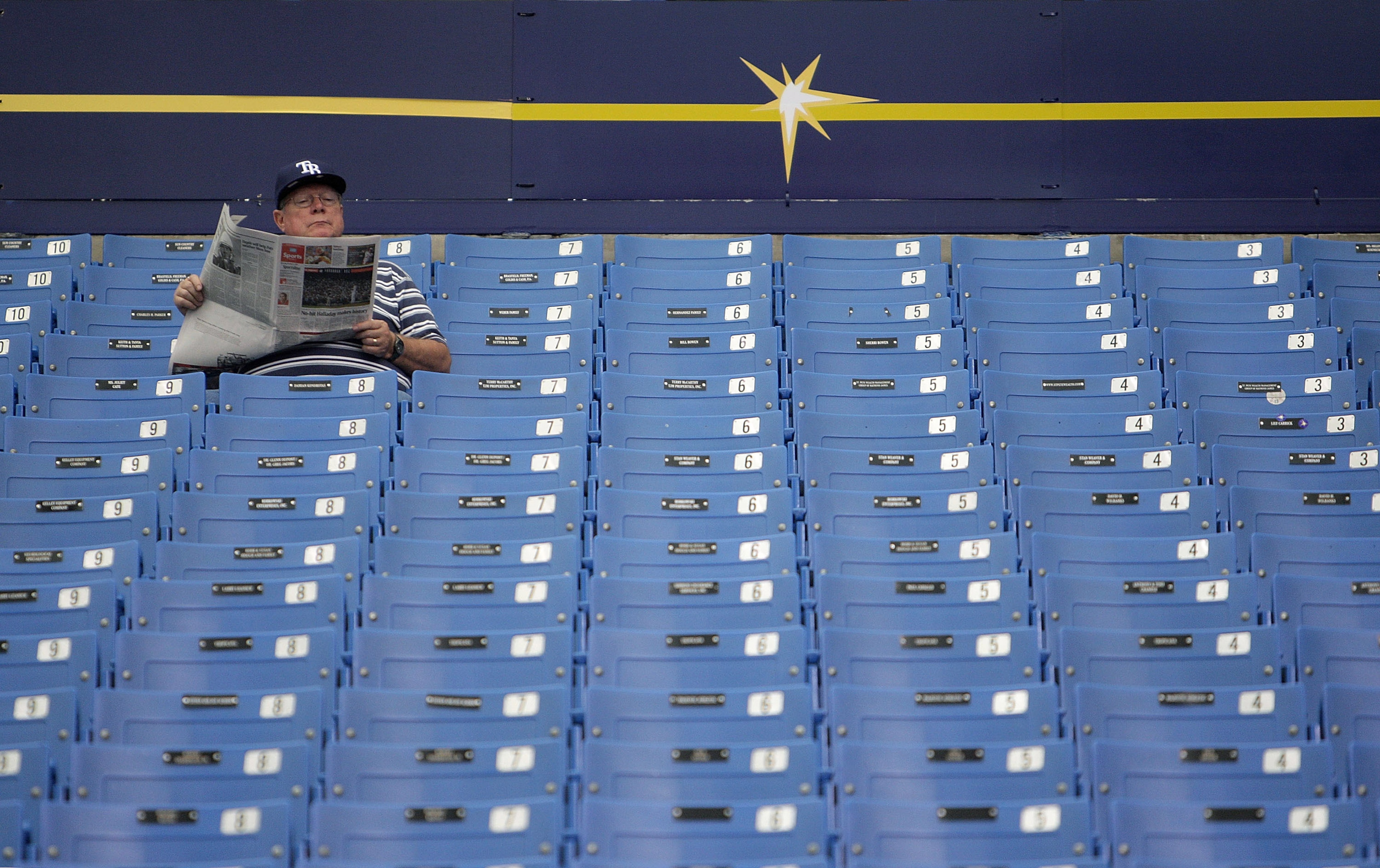 ST PETERSBURG, FL - OCTOBER 07: A Tampa Bay Rays fan reads the paper before Game 2 of the ALDS between the Tampa Bay Rays and the Texas Rangers at Tropicana Field on October 7, 2010 in St. Petersburg, Florida. (Photo by Mike Ehrmann/Getty Images) ST PETERSBURG, FL - OCTOBER 07: A Tampa Bay Rays fan reads the paper before Game 2 of the ALDS between the Tampa Bay Rays and the Texas Rangers at Tropicana Field on October 7, 2010 in St. Petersburg, Florida. (Photo by Mike Ehrmann/Getty Images)