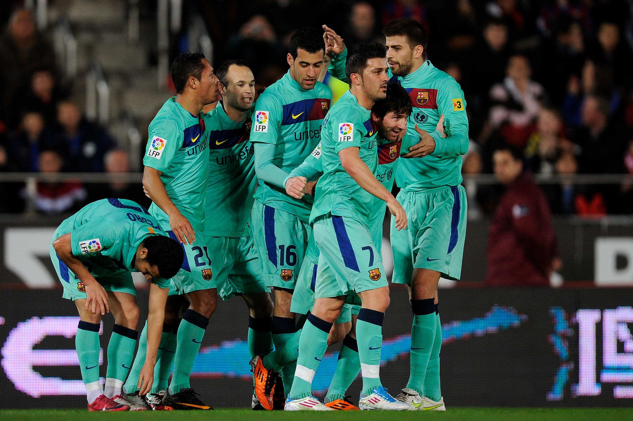 MALLORCA, SPAIN - FEBRUARY 26:  Lionel Messi of Barcelona (2ndL) celebrates with his teammates after scoring his first team's goal during the La Liga match between Mallorca and Barcelona at Iberstar Stadium on February 26, 2011 in Mallorca, Spain.  (Photo