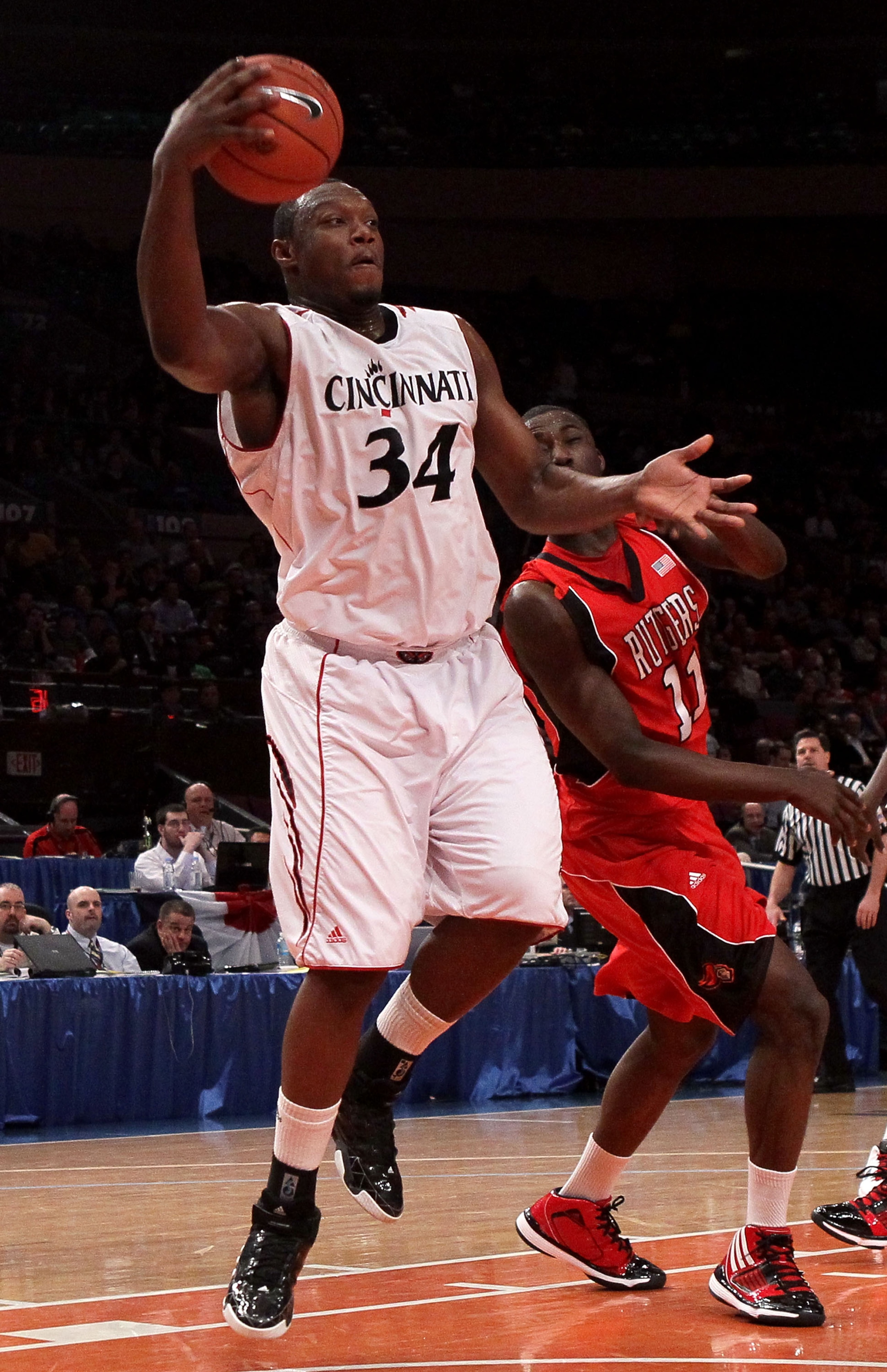 NEW YORK - MARCH 09: Yancy Gates #34 of the Cincinnati Bearcats grabs a loose ball against the Rutgers Scarlet Knights during the first round game of the Big East Basketball Tournament at Madison Square Garden on March 9, 2010 in New York, New York.  (Pho