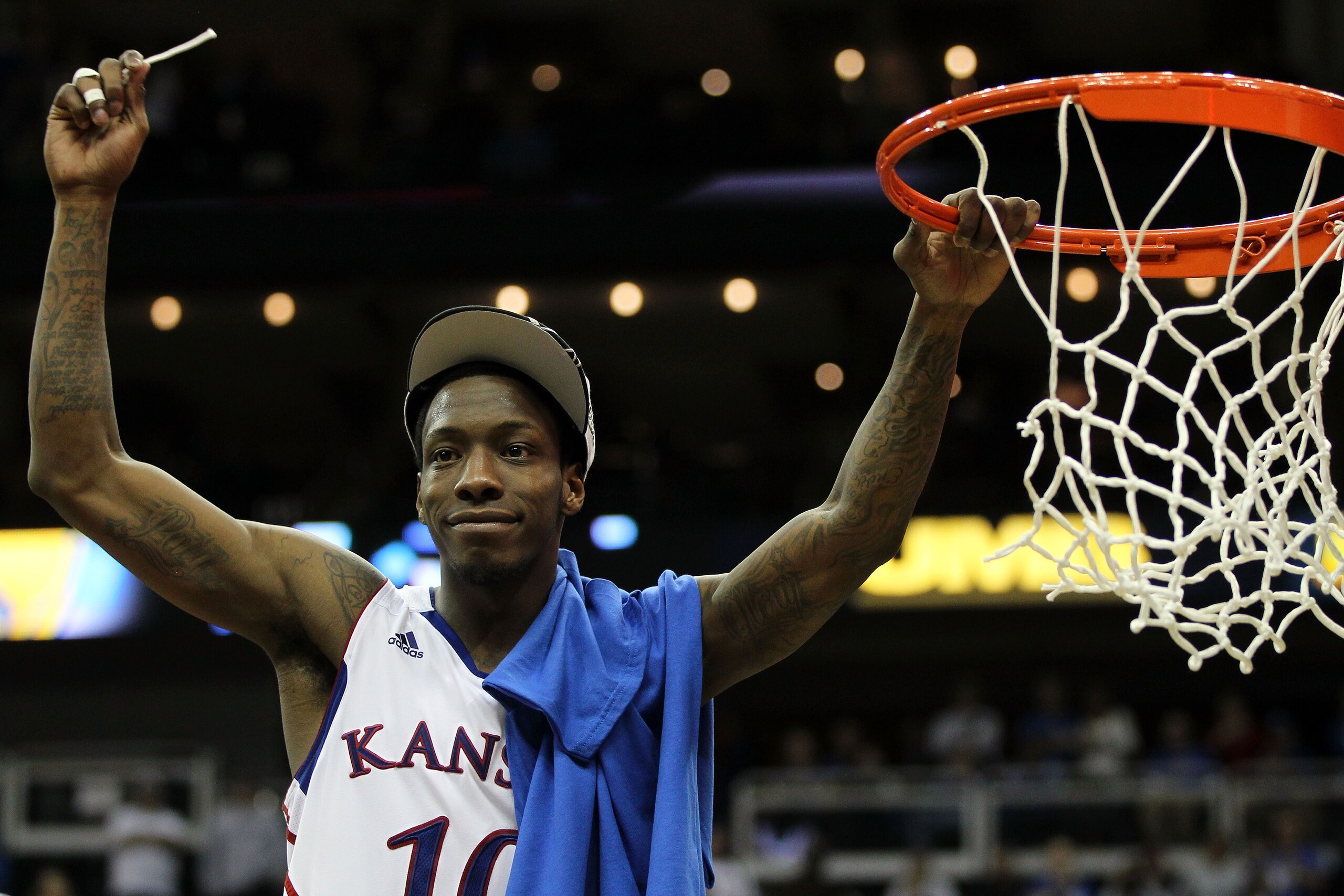 KANSAS CITY, MO - MARCH 12:  Tyshawn Taylor #10 of the Kansas Jayhawks cuts down the net after defeating the Texas Longhorns 85-73 to win the 2011 Phillips 66 Big 12 Men's Basketball Tournament championship game at Sprint Center on March 12, 2011 in Kansa