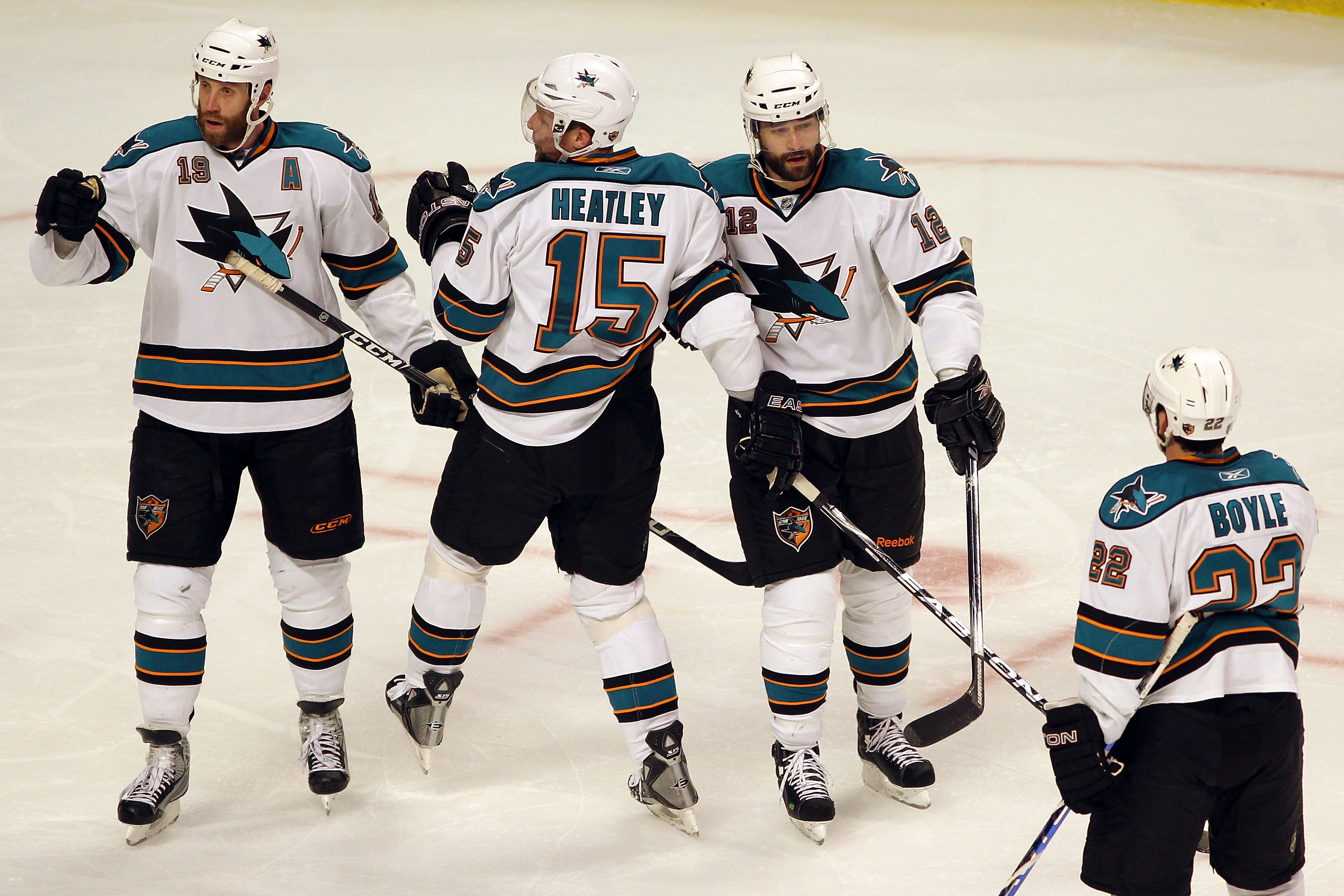 CHICAGO - MAY 21:  (L-R) Joe Thornton #19, Dany Heatley #15, Patrick Marleau #12 and Dan Boyle #12 of the San Jose Sharks react after the second period goal by Marleau while taking on the Chicago Blackhawks in Game Three of the Western Conference Finals d