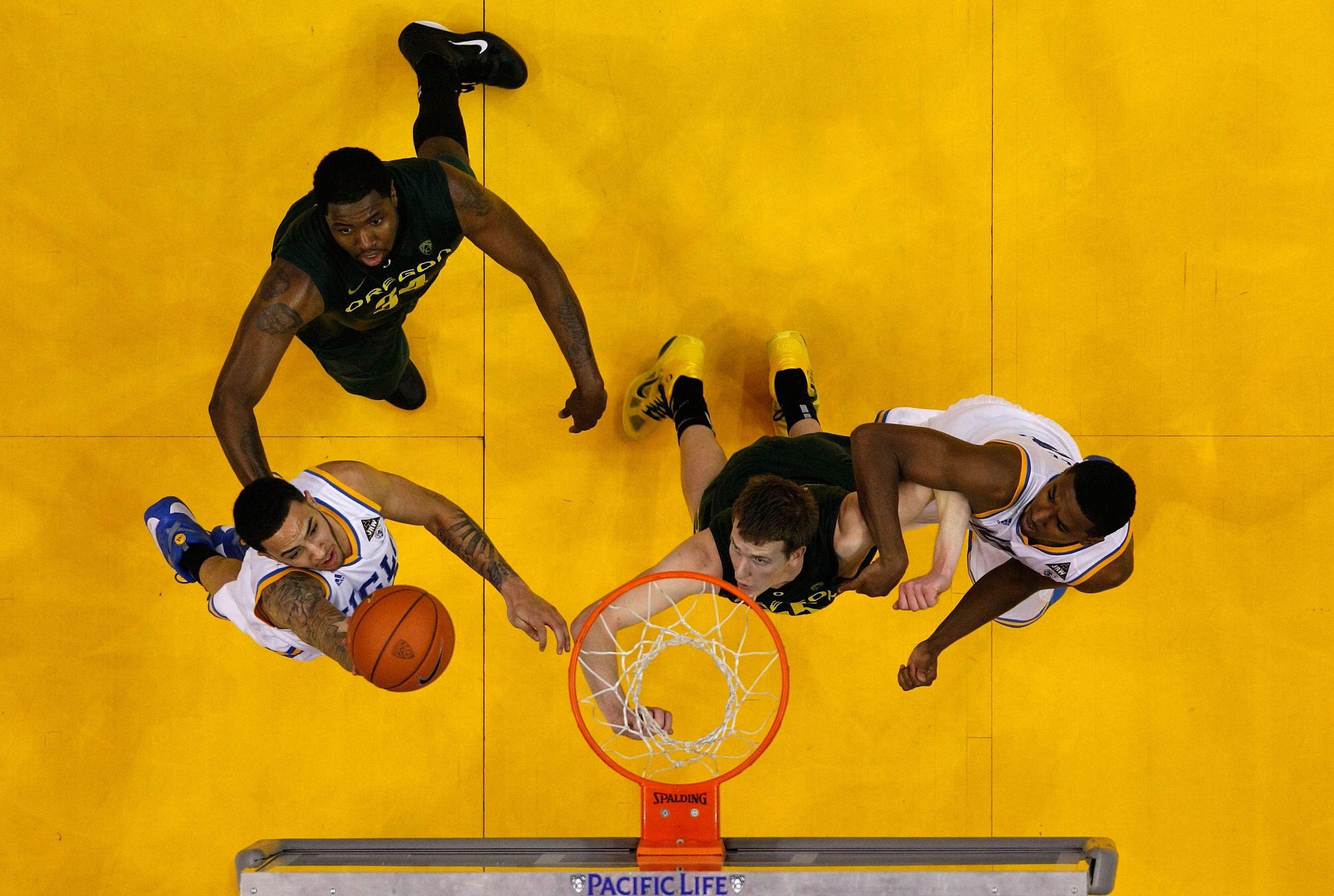 LOS ANGELES, CA - MARCH 10: Tyler Honeycutt #23 of the UCLA Bruins lays the ball up between Joevan Catron #34 and E.J. Singler #25 of the Oregon Ducks in the quarterfinals of the 2011 Pacific Life Pac-10 Men's Basketball Tournament at Staples Center on M LOS ANGELES, CA - MARCH 10: Tyler Honeycutt #23 of the UCLA Bruins lays the ball up between Joevan Catron #34 and E.J. Singler #25 of the Oregon Ducks in the quarterfinals of the 2011 Pacific Life Pac-10 Men's Basketball Tournament at Staples Center on M