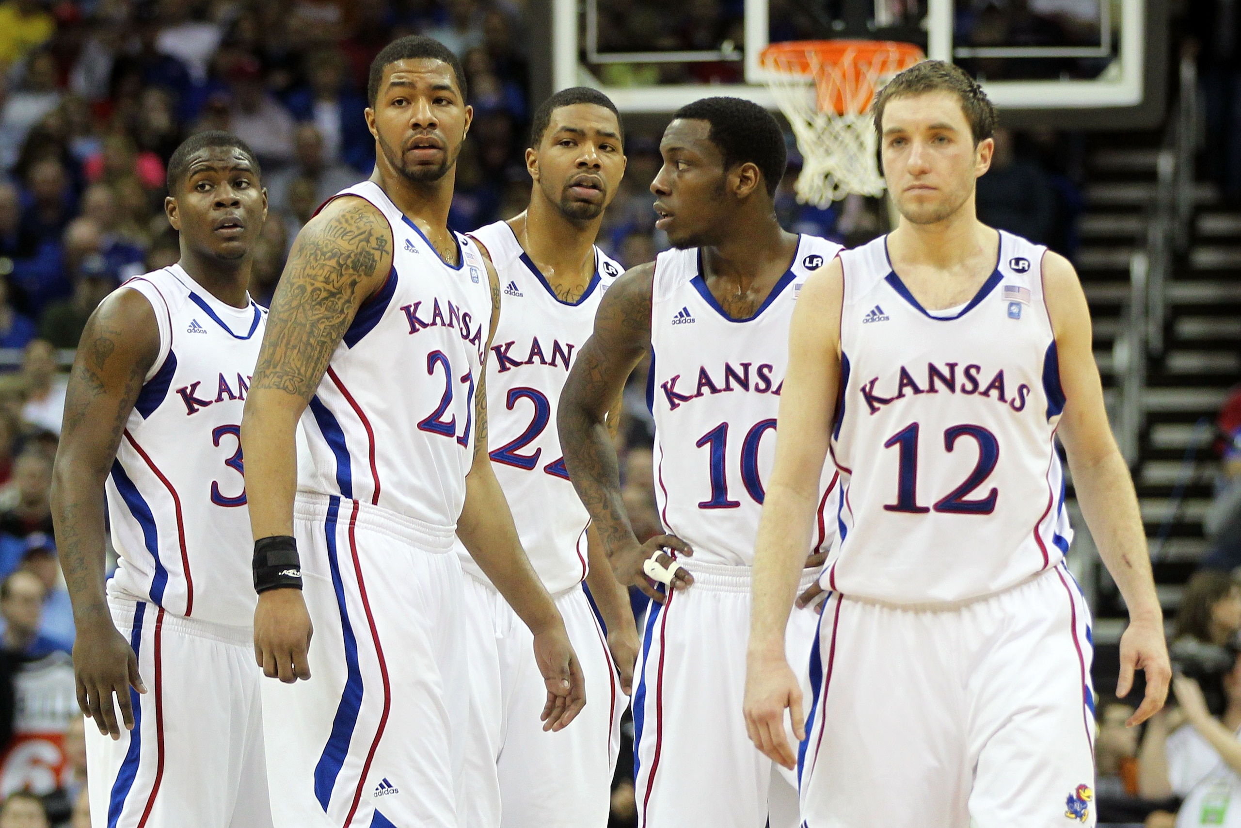 KANSAS CITY, MO - MARCH 12:  Josh Selby #32, Markieff Morris #21, Marcus Morris #22,Tyshawn Taylor #10 and Brady Morningstar #12 of the Kansas Jayhawks stand on the court against the Texas Longhorns during the 2011 Phillips 66 Big 12 Men's Basketball Tour