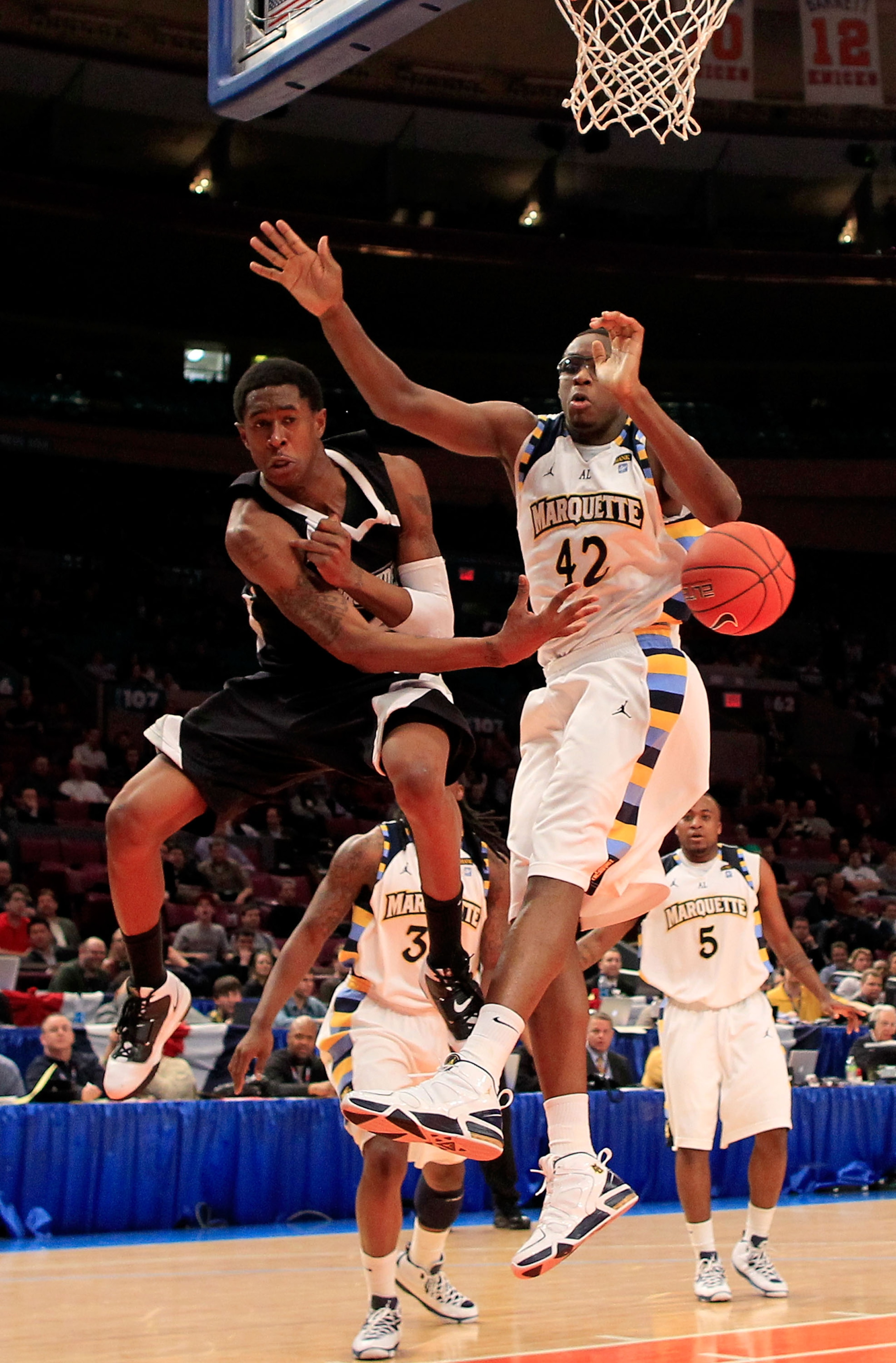 NEW YORK, NY - MARCH 08: Marshon Brooks #2 of the Providence Friars passes the ball against Chris Otule #42 of the Marquette Golden Eagles during the first round of the 2011 Big East Men's Basketball Tournament presented by American Eagle Outfitters at Ma NEW YORK, NY - MARCH 08: Marshon Brooks #2 of the Providence Friars passes the ball against Chris Otule #42 of the Marquette Golden Eagles during the first round of the 2011 Big East Men's Basketball Tournament presented by American Eagle Outfitters at Ma