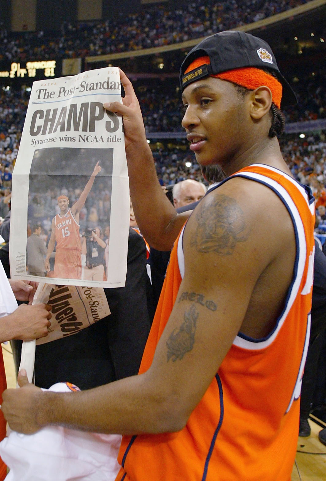 NEW ORLEANS - APRIL 7:  Carmelo Anthony #15 of Syracuse holds up tommorows paper which declares the Orangeman national champs after he and his team defeated Kansas 81-78 during the championship game of the NCAA Men's Final Four Tournament on April 7, 2003
