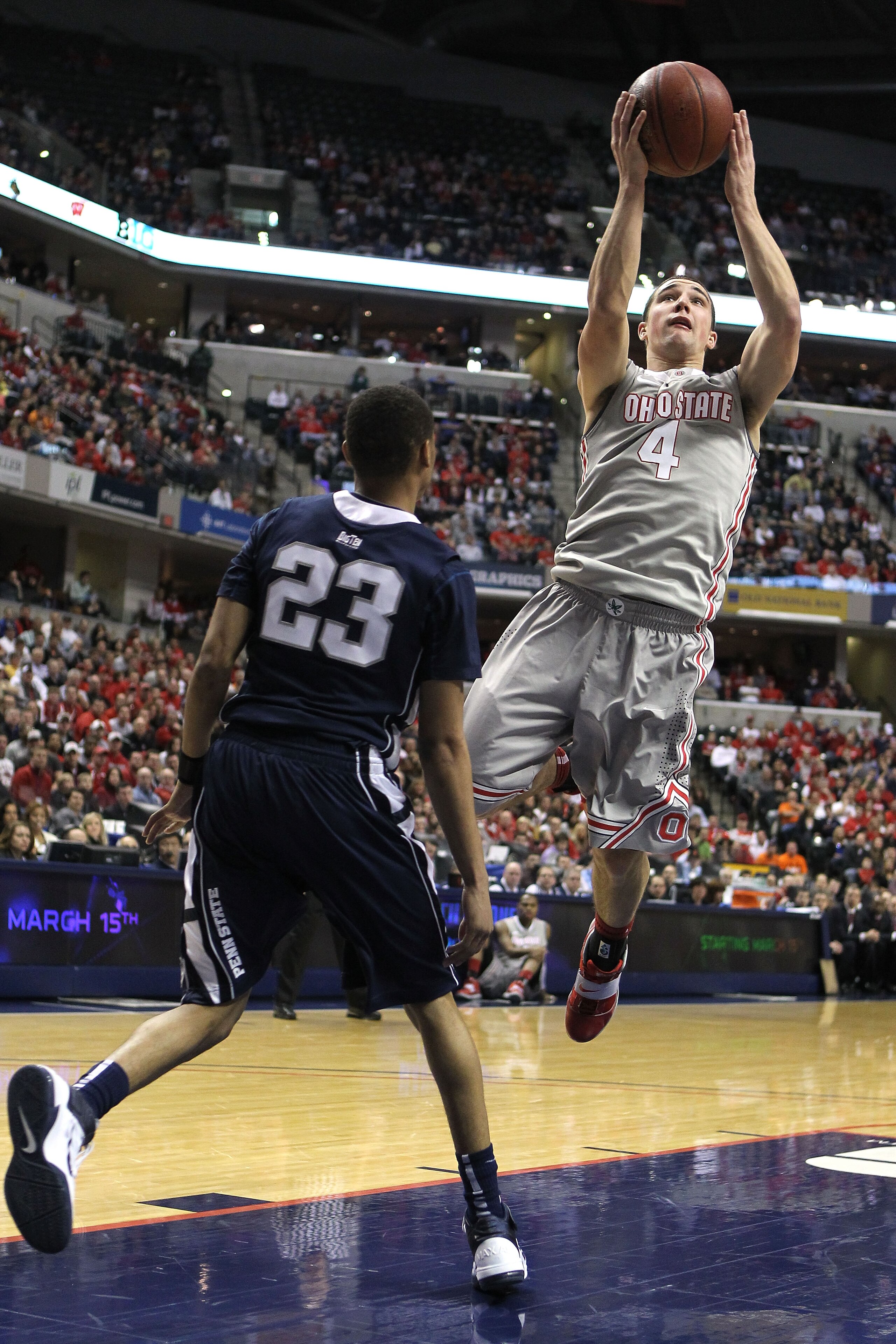 INDIANAPOLIS, IN - MARCH 13: Aaron Craft #4 of the Ohio State Buckeyes drives for a shot attempt against Tim Frazier #23 of the Penn State Nittany Lions during the championship game of the 2011 Big Ten Men's Basketball Tournament at Conseco Fieldhouse on INDIANAPOLIS, IN - MARCH 13: Aaron Craft #4 of the Ohio State Buckeyes drives for a shot attempt against Tim Frazier #23 of the Penn State Nittany Lions during the championship game of the 2011 Big Ten Men's Basketball Tournament at Conseco Fieldhouse on