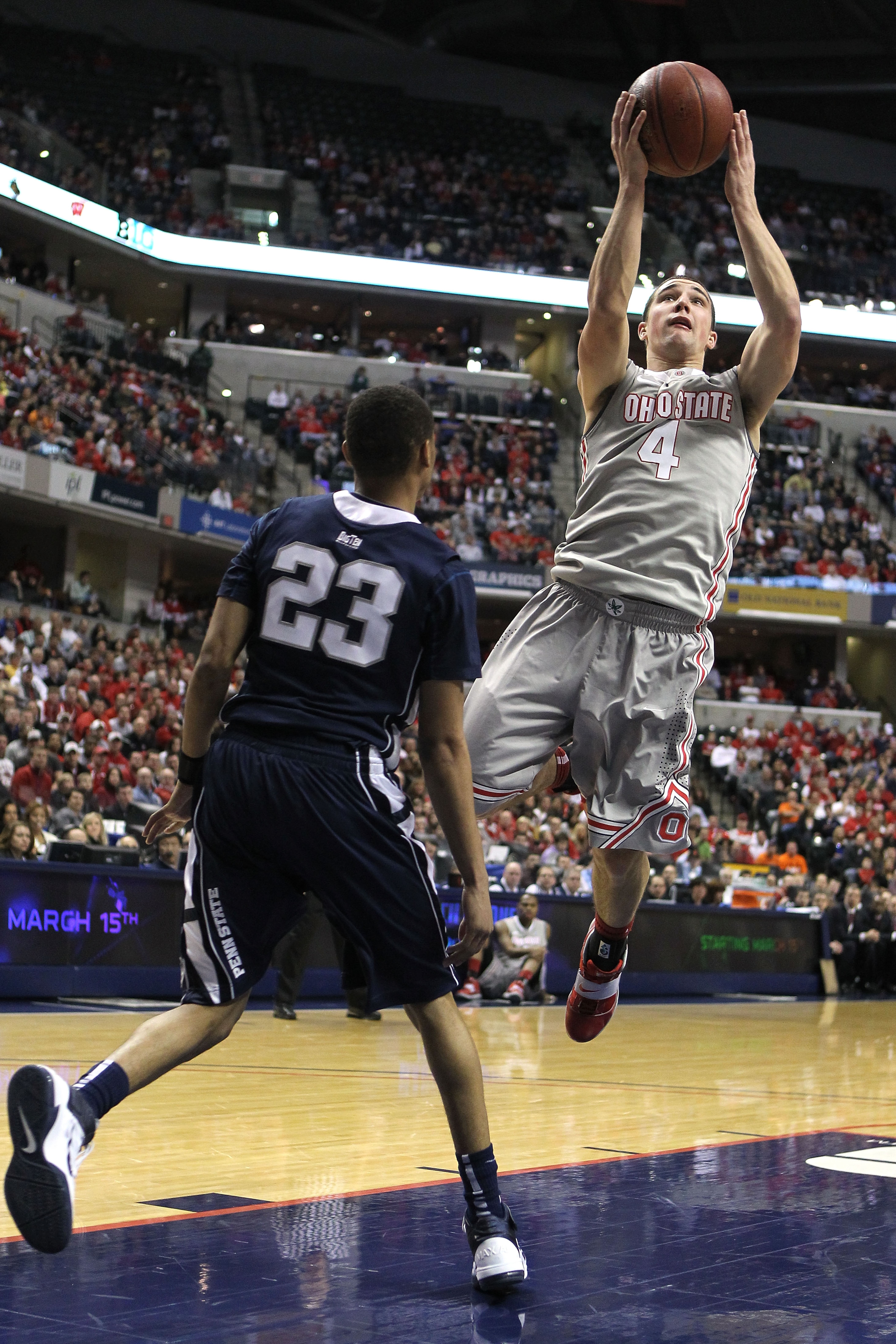 INDIANAPOLIS, IN - MARCH 13:  Aaron Craft #4 of the Ohio State Buckeyes drives for a shot attempt against Tim Frazier #23 of the Penn State Nittany Lions during the championship game of the 2011 Big Ten Men's Basketball Tournament at Conseco Fieldhouse on