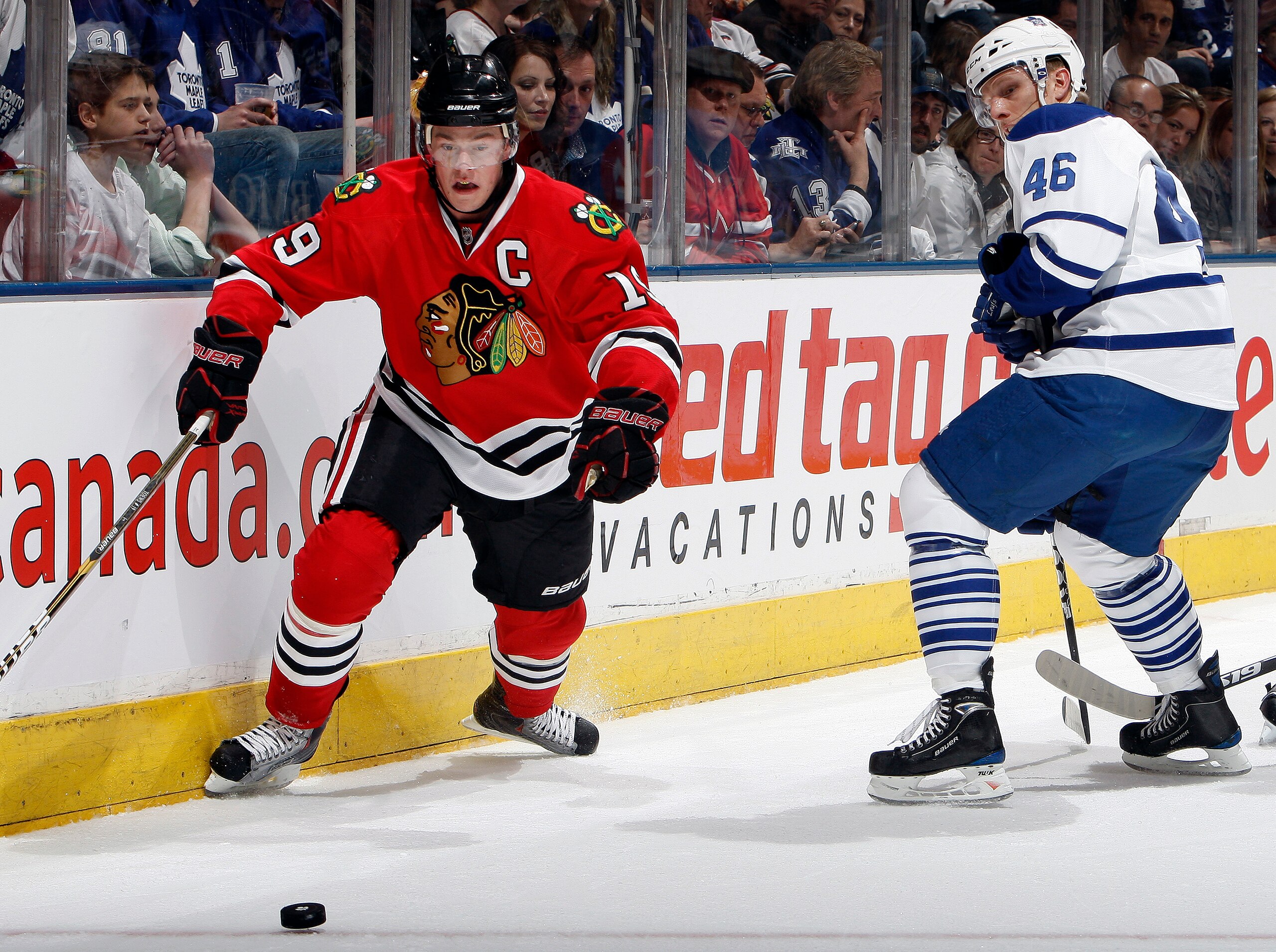 TORONTO, CANADA - MARCH 5: Joey Crabb #46 of the Toronto Maple Leafs battles for the puck against Jonathan Toews #19 of the Chicago Blackhawks during game action at the Air Canada Centre March 5, 2011 in Toronto, Ontario, Canada. (Photo by Abelimages/Gett