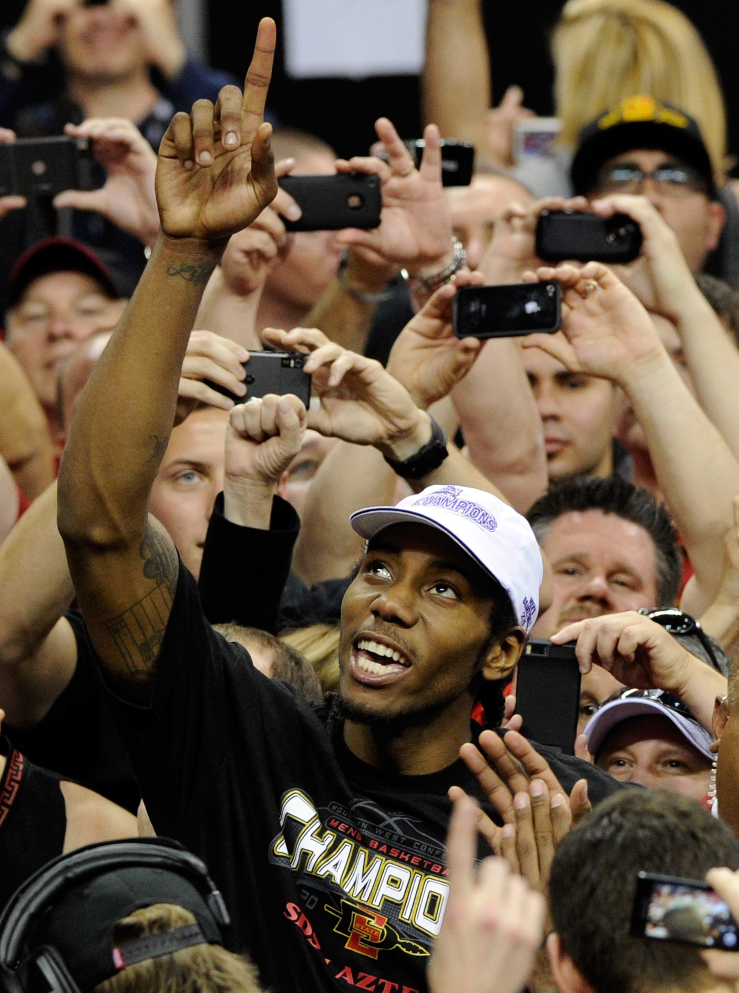 LAS VEGAS, NV - MARCH 12: Kawhi Leonard #15 of the San Diego State Aztecs celebrates with fans after the team's 72-54 victory over the Brigham Young University Cougars in the championship game of the Conoco Mountain West Conference Basketball tournament LAS VEGAS, NV - MARCH 12: Kawhi Leonard #15 of the San Diego State Aztecs celebrates with fans after the team's 72-54 victory over the Brigham Young University Cougars in the championship game of the Conoco Mountain West Conference Basketball tournament