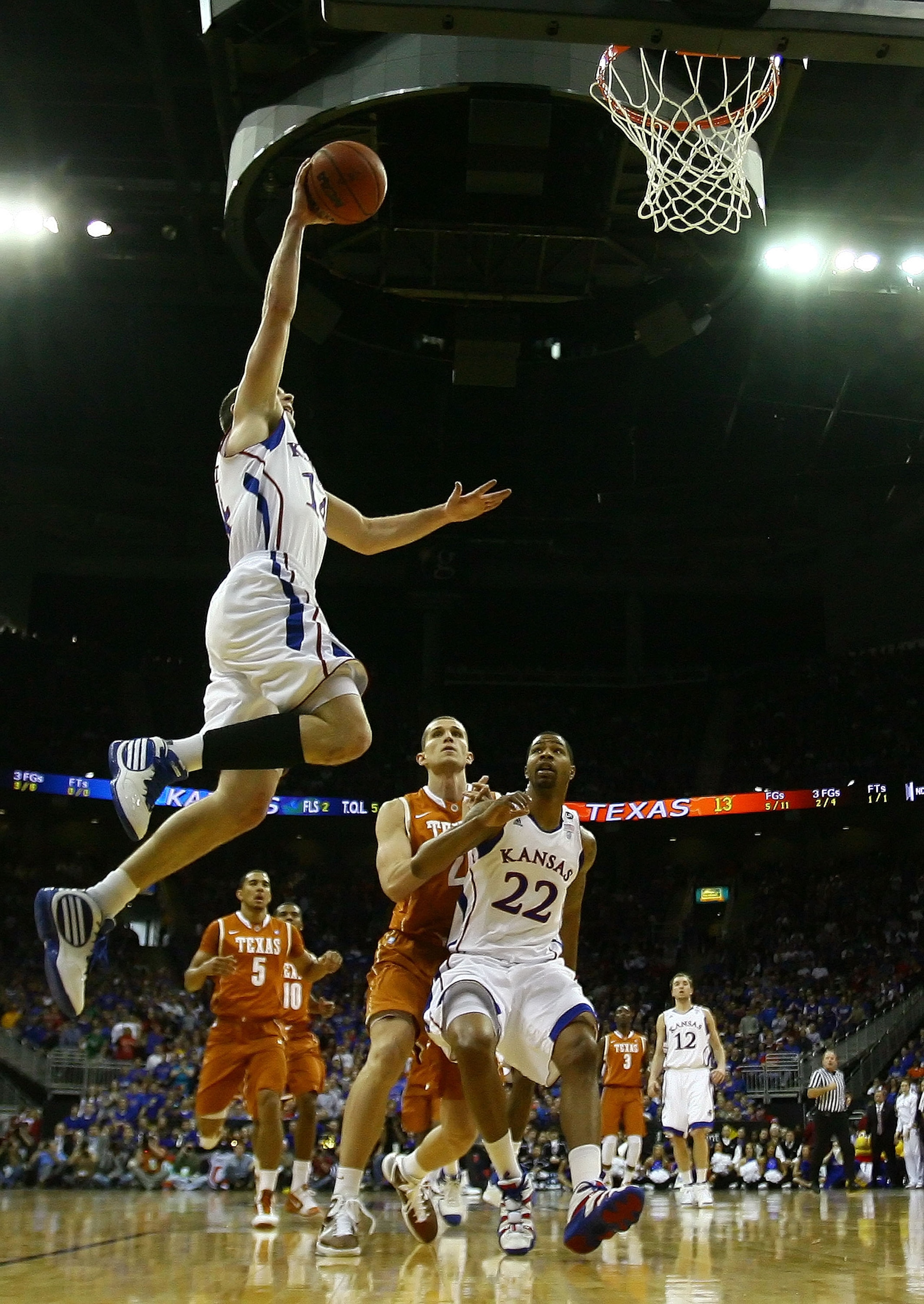 KANSAS CITY, MO - MARCH 12:  Tyrel Reed #14 of the Kansas Jayhawks dunks the ball against the Texas Longhorns in the first half of the 2011 Phillips 66 Big 12 Men's Basketball Tournament championship game at Sprint Center on March 12, 2011 in Kansas City,