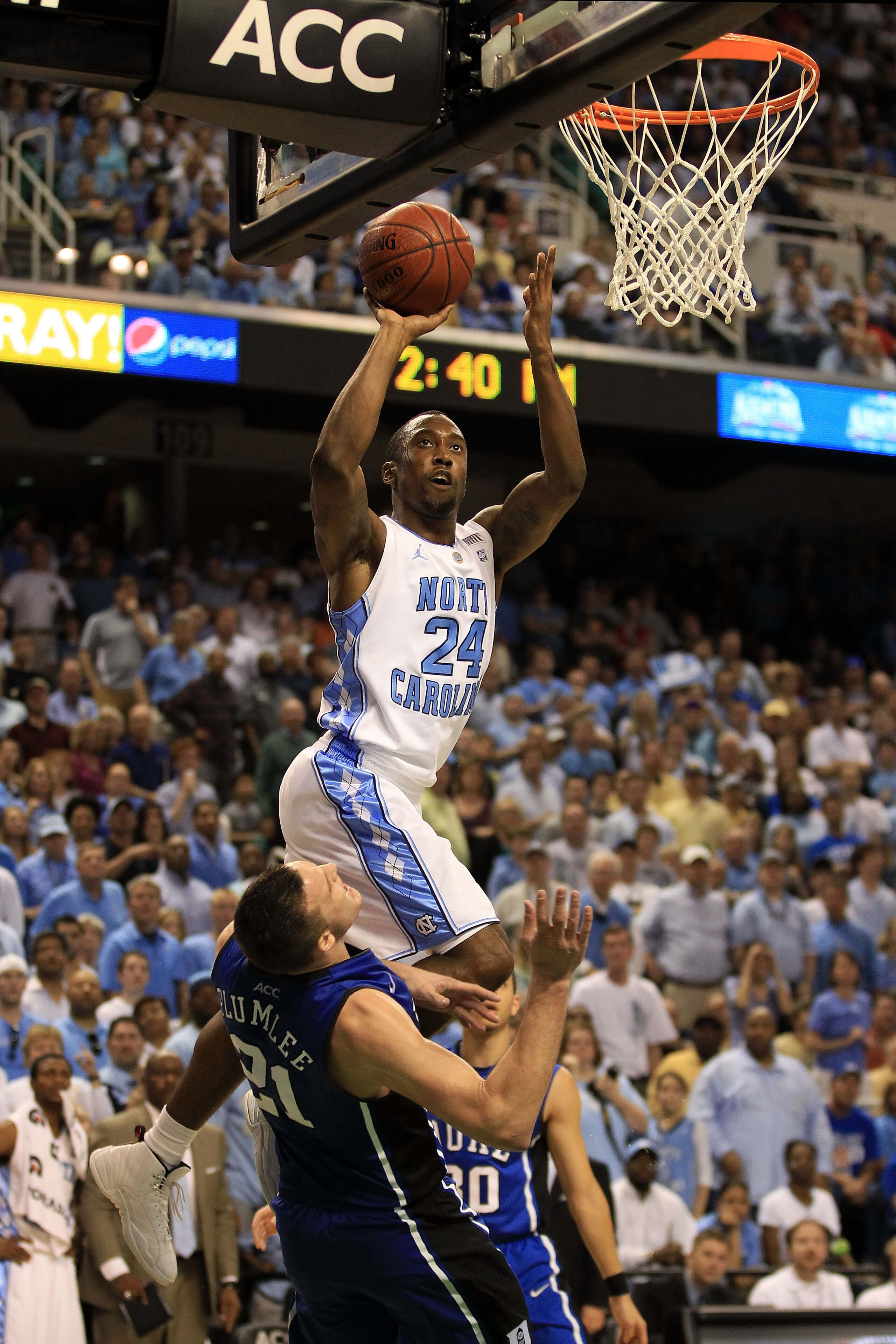 GREENSBORO, NC - MARCH 13: Justin Watts #24 of the North Carolina Tar Heels shoots against Miles Plumlee #21 of the Duke Blue Devils during the second half in the championship game of the 2011 ACC men's basketball tournament at the Greensboro Coliseum on GREENSBORO, NC - MARCH 13: Justin Watts #24 of the North Carolina Tar Heels shoots against Miles Plumlee #21 of the Duke Blue Devils during the second half in the championship game of the 2011 ACC men's basketball tournament at the Greensboro Coliseum on