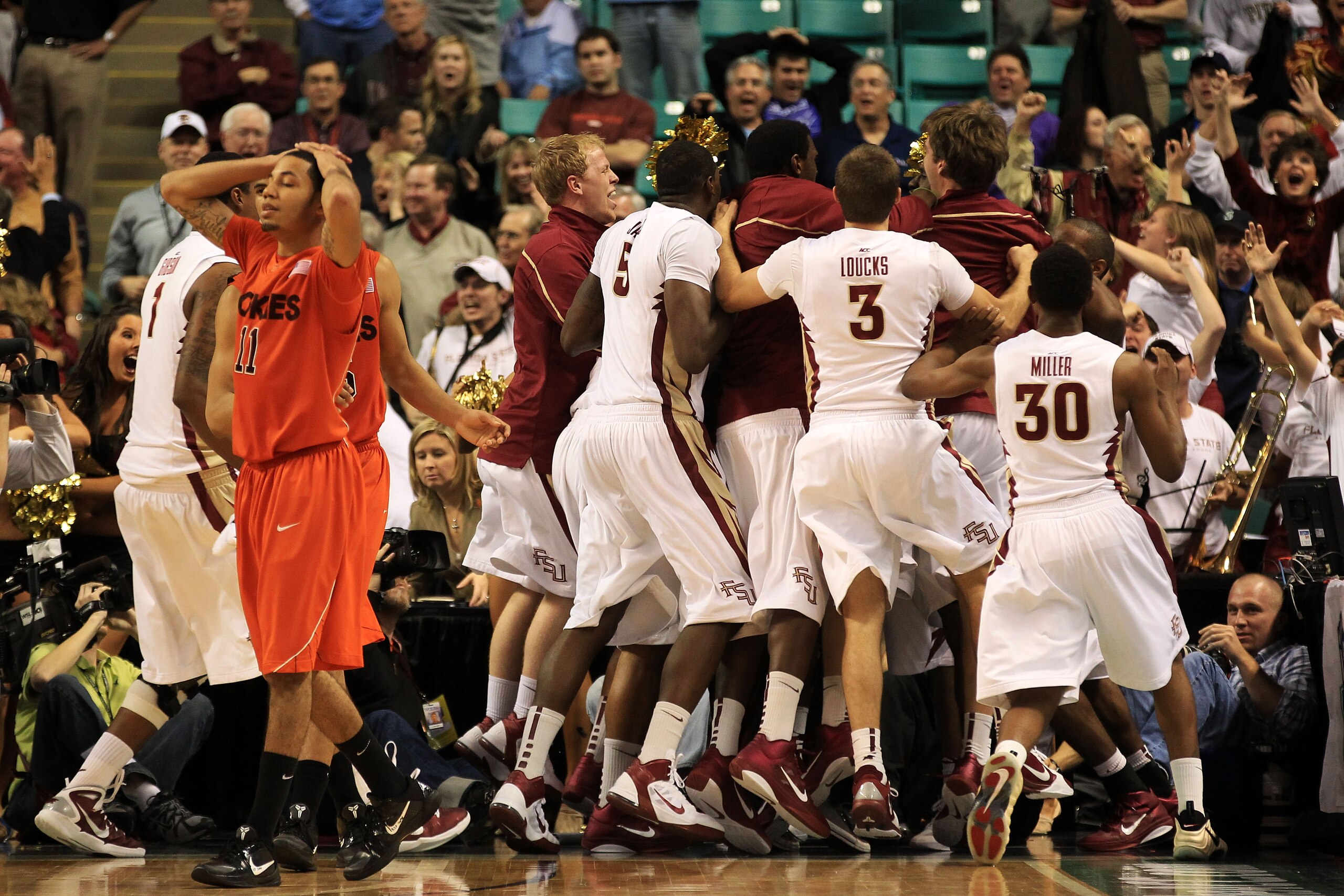 GREENSBORO, NC - MARCH 11:  Erick Green #11 of the Virginia Tech Hokies reacts to a shot at the buzzer by Derwin Kitchen #22 of the Florida State Seminoles as the Seminoles celebrate what would have been a victory for them during the quarterfinals of the