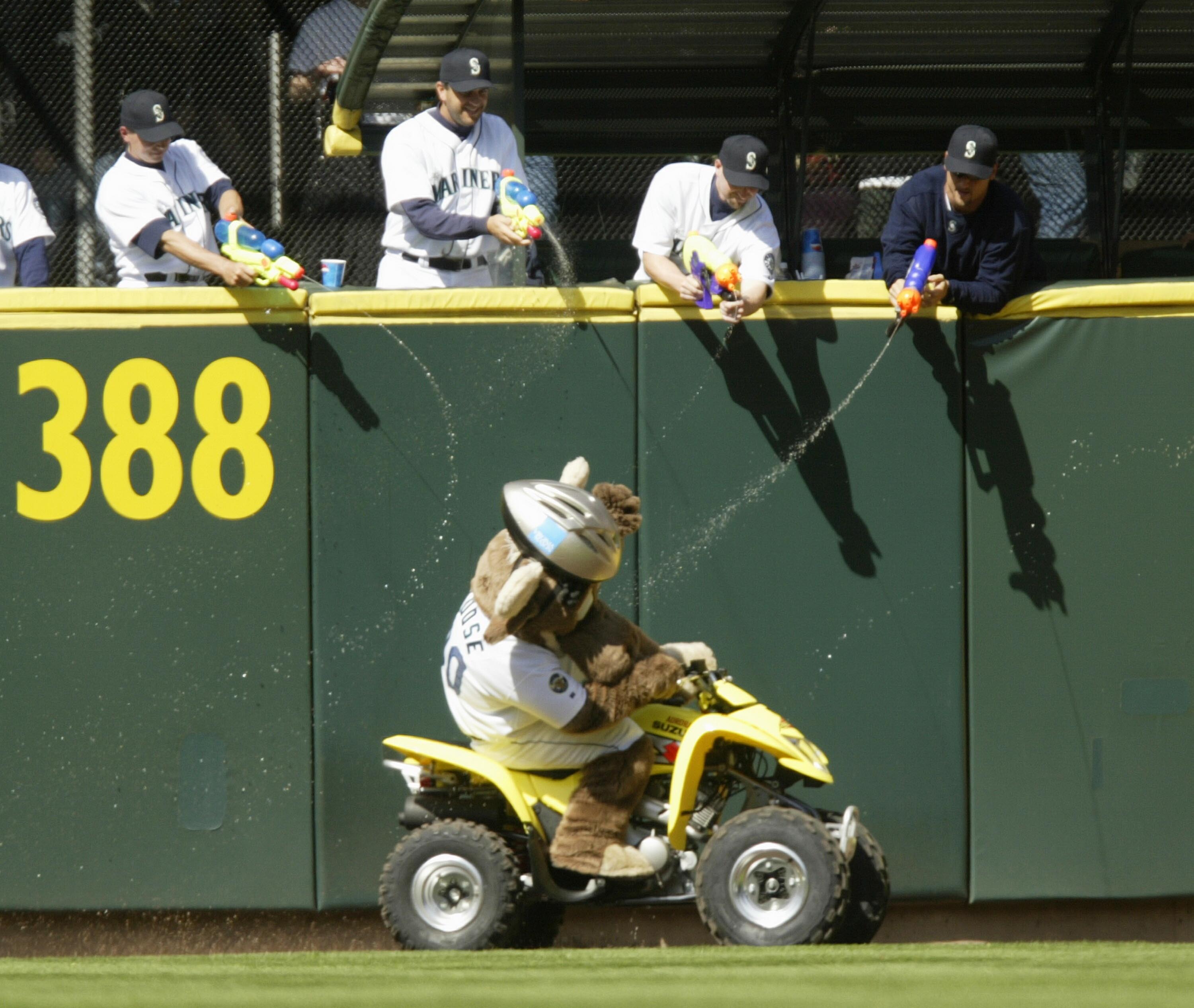 SEATTLE - APRIL 22:  Members of the Seattle Mariners' bullpen, armed with squirt guns, fire upon the team mascot 'Mariner Moose' as he makes his traditional lap around the field during the seventh inning stretch against the Oakland Athletics on April 22,