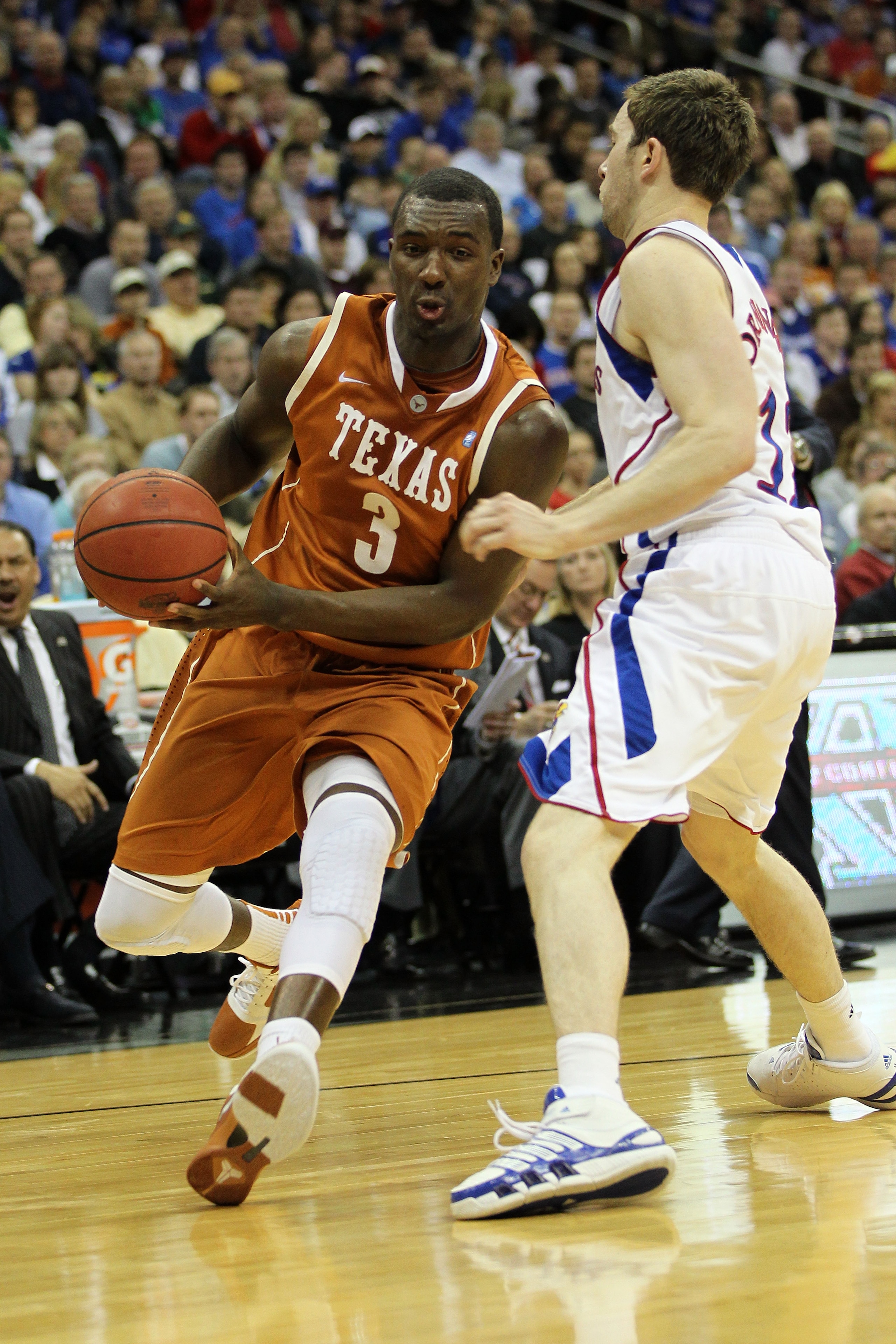 KANSAS CITY, MO - MARCH 12:  Jordan Hamilton #3 of the Texas Longhorns drives with the ball against Brady Morningstar #12 of the Kansas Jayhawks during the 2011 Phillips 66 Big 12 Men's Basketball Tournament championship game at Sprint Center on March 12,