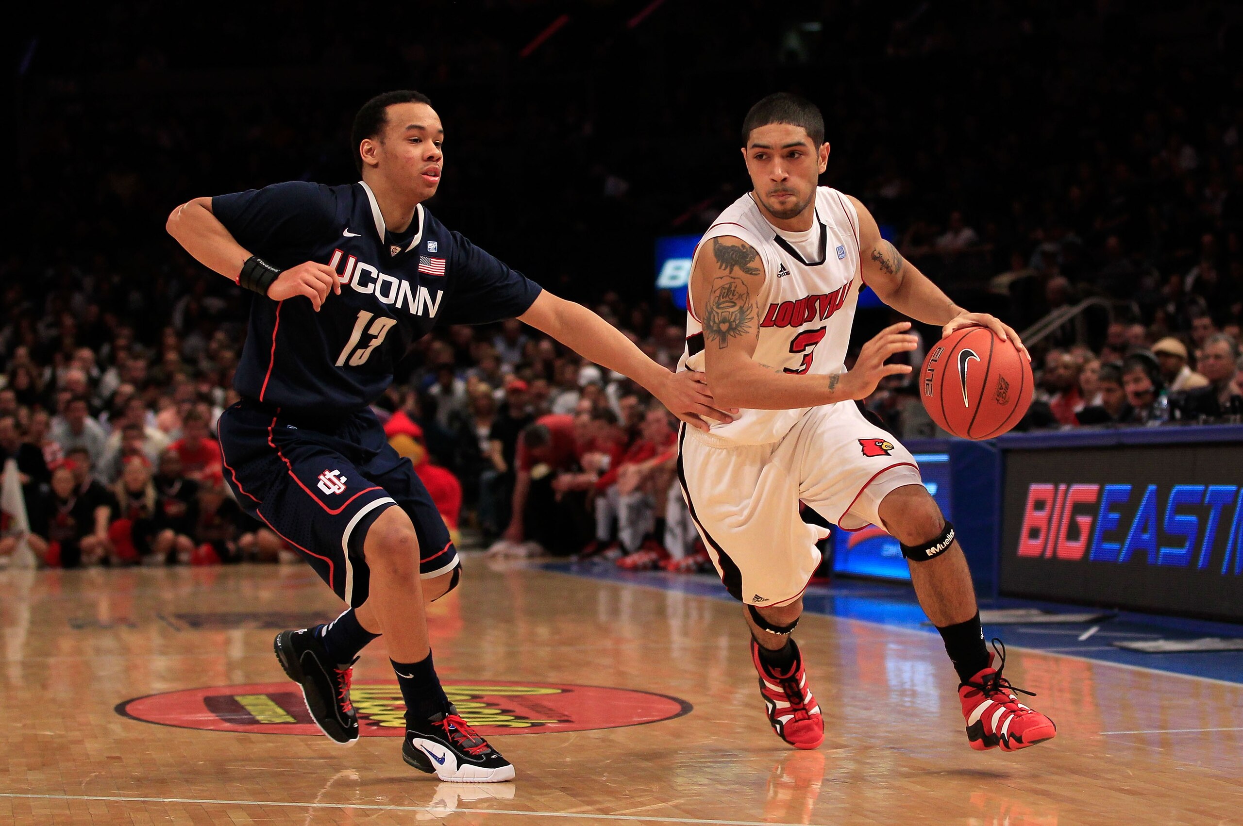 NEW YORK, NY - MARCH 12: Peyton Siva #3 of the Louisville Cardinals drives with the ball against Shabazz Napier #13 of the Connecticut Huskies during the championship of the 2011 Big East Men's Basketball Tournament presented by American Eagle Outfitters NEW YORK, NY - MARCH 12: Peyton Siva #3 of the Louisville Cardinals drives with the ball against Shabazz Napier #13 of the Connecticut Huskies during the championship of the 2011 Big East Men's Basketball Tournament presented by American Eagle Outfitters