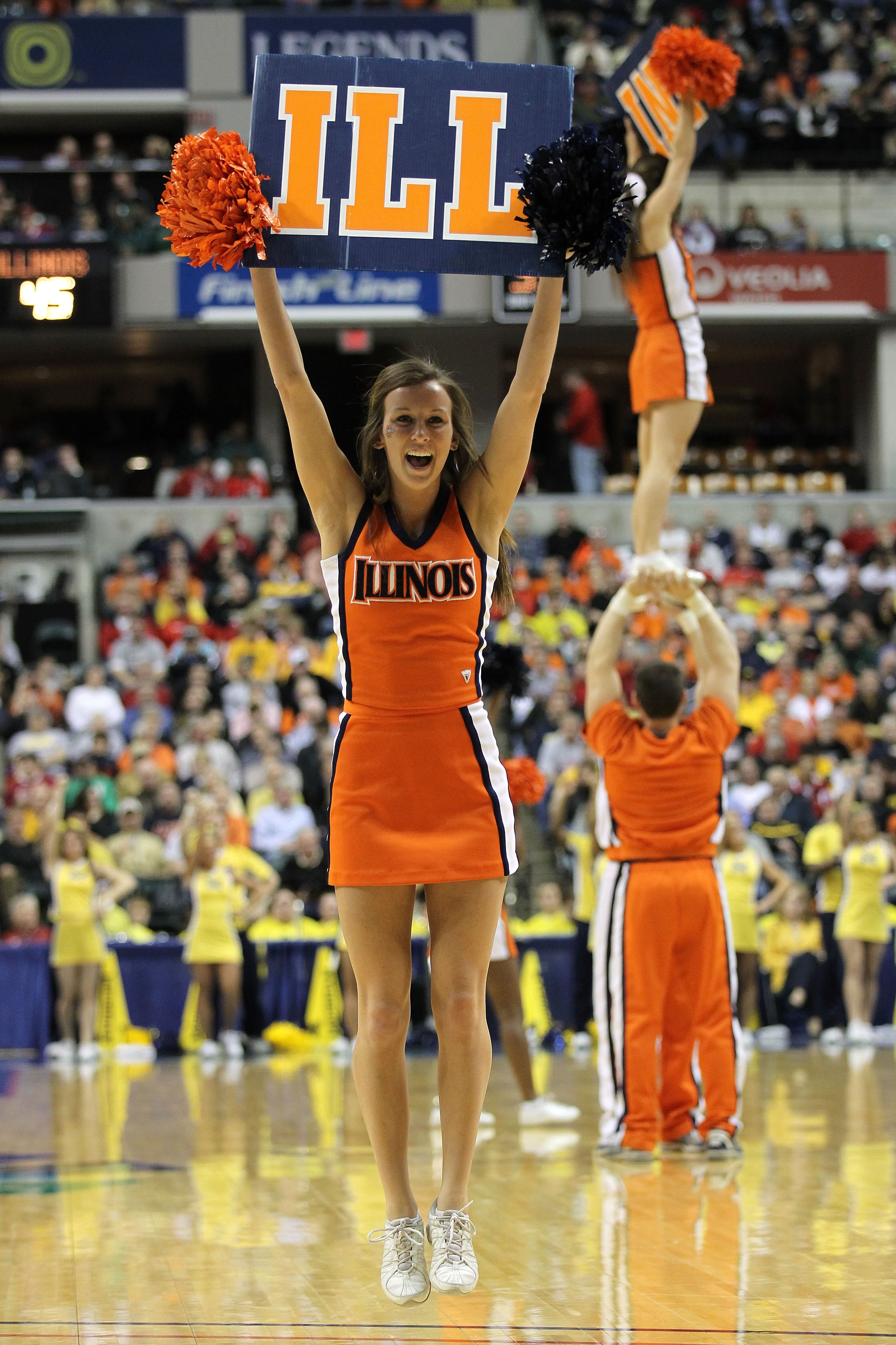 INDIANAPOLIS, IN - MARCH 11: Cheerleaders for the Illinois Fighting Illini perform against the Michigan Wolverines during the quarterfinals of the 2011 Big Ten Men's Basketball Tournament at Conseco Fieldhouse on March 11, 2011 in Indianapolis, Indiana. INDIANAPOLIS, IN - MARCH 11: Cheerleaders for the Illinois Fighting Illini perform against the Michigan Wolverines during the quarterfinals of the 2011 Big Ten Men's Basketball Tournament at Conseco Fieldhouse on March 11, 2011 in Indianapolis, Indiana.