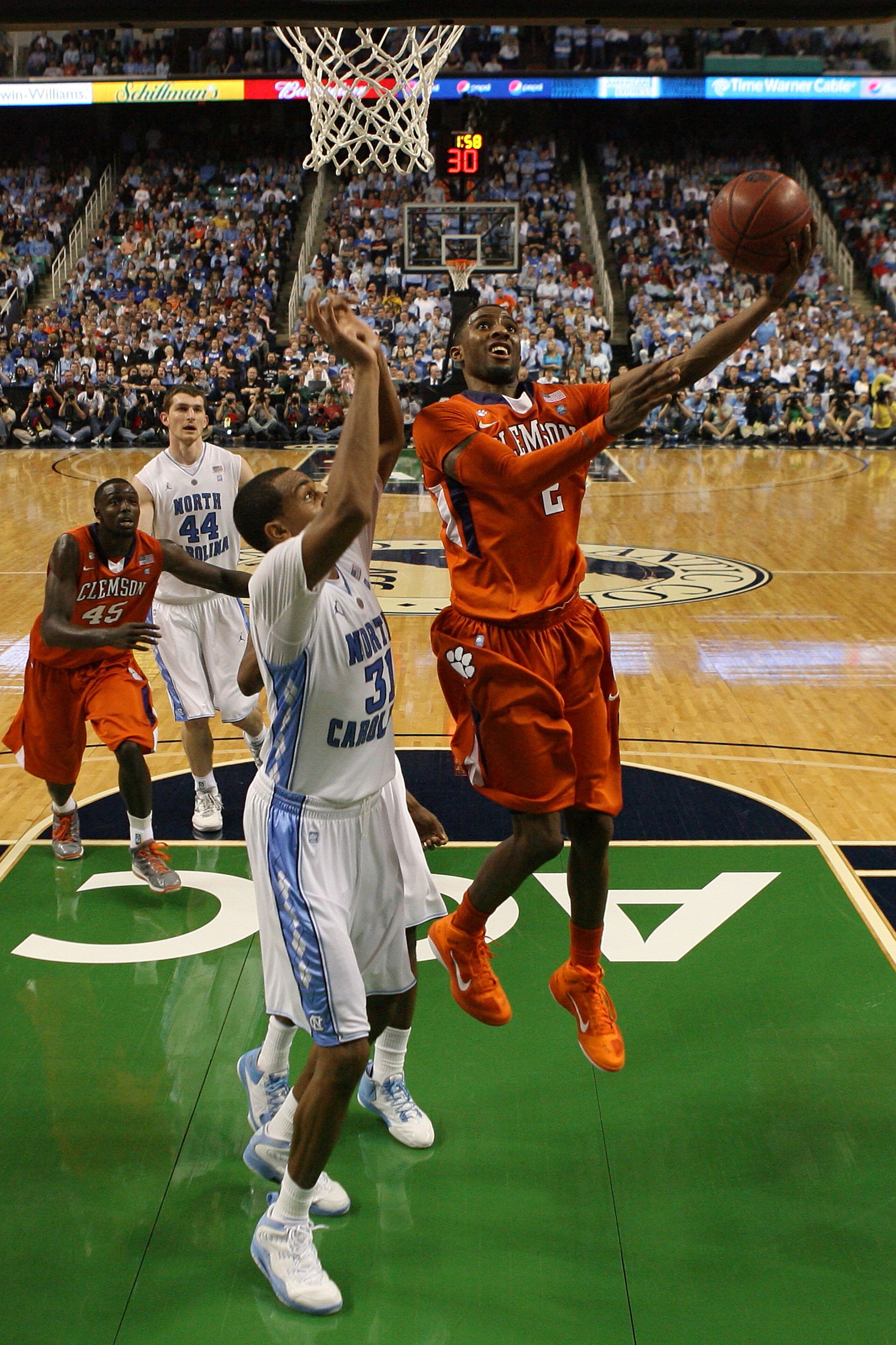 GREENSBORO, NC - MARCH 12:  Demontez Stitt #2 of the Clemson Tigers shoots against John Henson #31 of the North Carolina Tar Heels in the semifinals of the 2011 ACC men's basketball tournament at the Greensboro Coliseum on March 12, 2011 in Greensboro, No