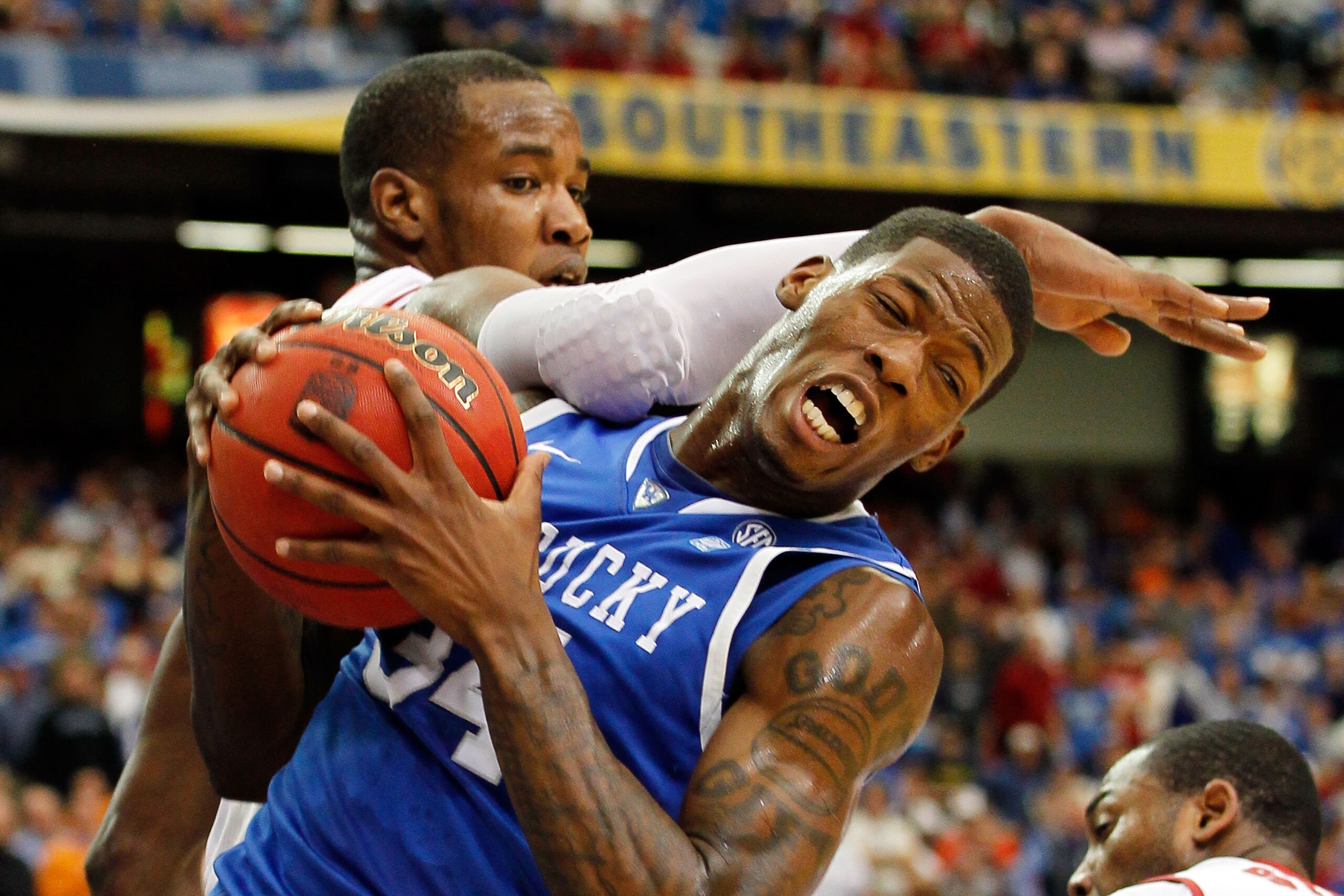 ATLANTA, GA - MARCH 12:  Chris Hines #44 of the Alabama Crimson Tide comes down on DeAndre Liggins #34 of the Kentucky Wildcats as he grabs a rebound during the semifinals of the SEC Men's Basketball Tournament at Georgia Dome on March 12, 2011 in Atlanta