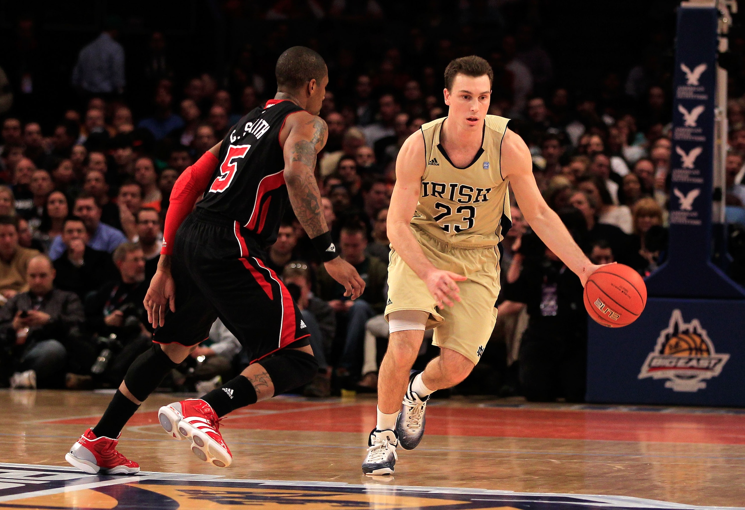 NEW YORK, NY - MARCH 11: Ben Hansbrough #23 of the Notre Dame Fighting Irish brings the ball up court against Chris Smith #5 of the Louisville Cardinals during the semifinals of the 2011 Big East Men's Basketball Tournament presented by American Eagle Ou NEW YORK, NY - MARCH 11: Ben Hansbrough #23 of the Notre Dame Fighting Irish brings the ball up court against Chris Smith #5 of the Louisville Cardinals during the semifinals of the 2011 Big East Men's Basketball Tournament presented by American Eagle Ou