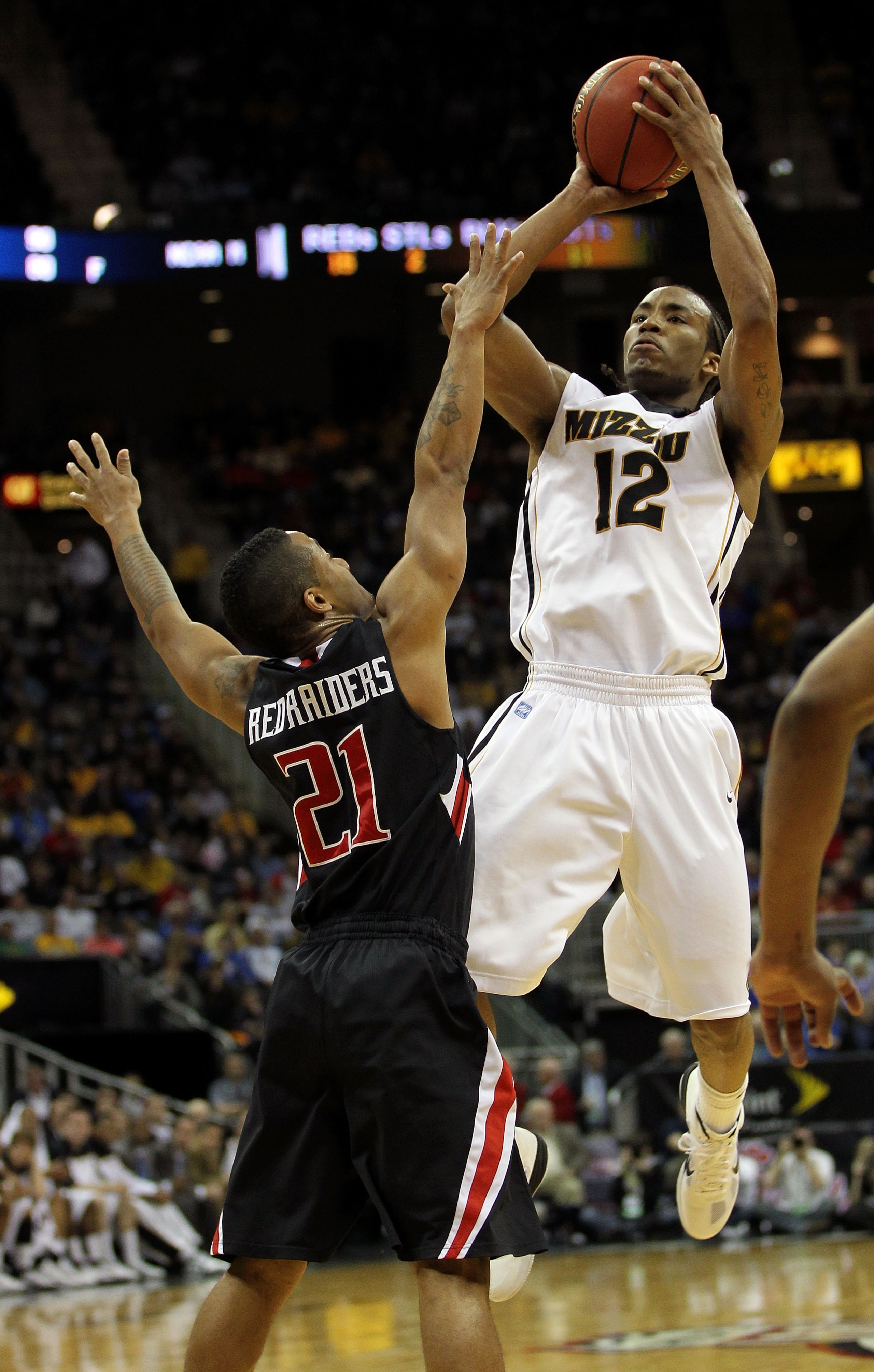 KANSAS CITY, MO - MARCH 09:  Marcus Denmon #12 of the Missouri Tigers shoots the ball against John Roberson #21 of the Texas Tech Red Raiders during their first round game in the 2011 Phillips 66 Big 12 Men's Basketball Tournament at Sprint Center on Marc