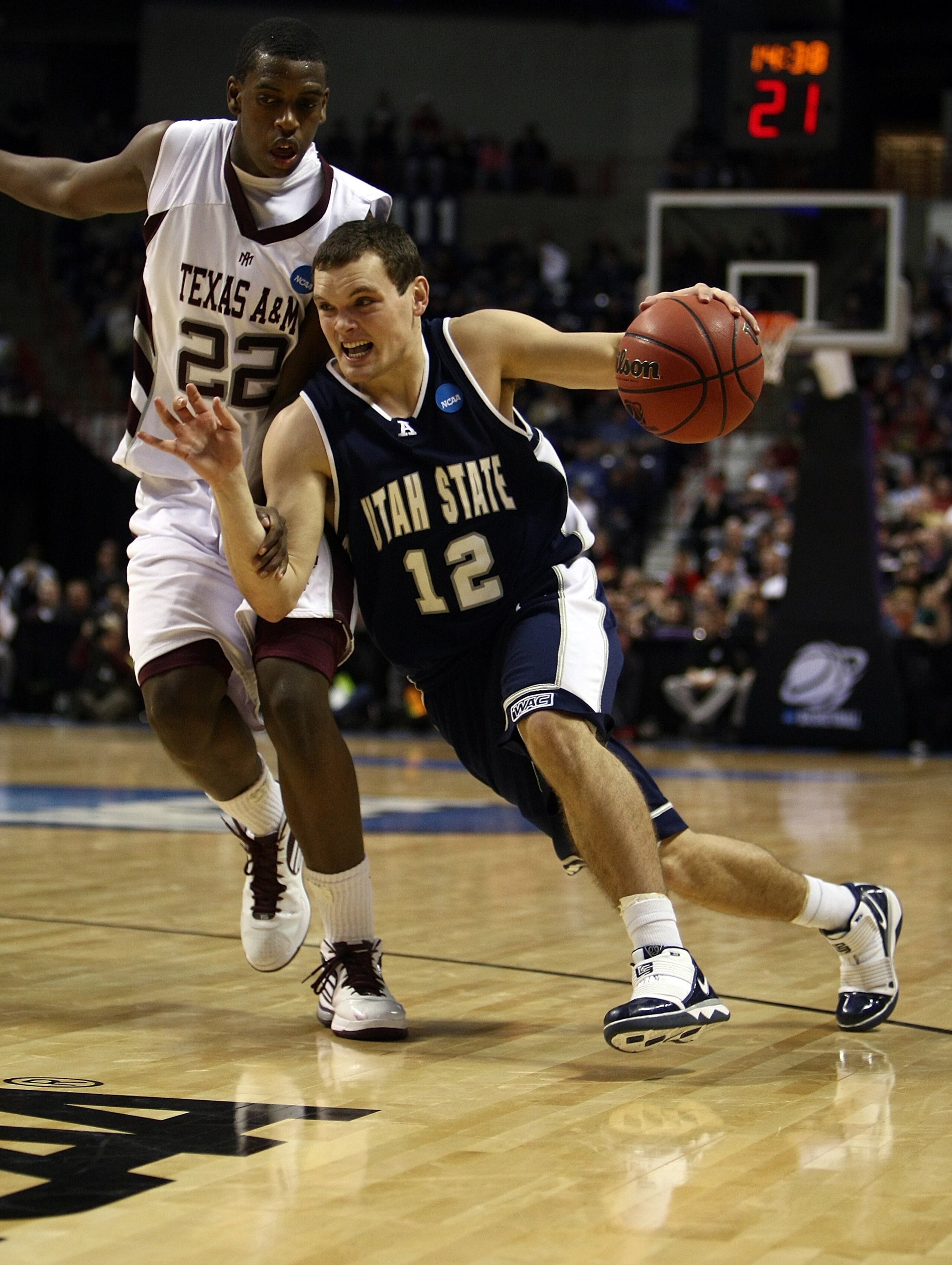 SPOKANE, WA - MARCH 19:   Brian Green #12 of the Utah St. Aggies drives against Khris Middleton #22 of the Texas A&M Aggies during the first round of the 2010 NCAA men's basketball tournament at Spokane Arena on March 19, 2010 in Spokane, Washington.  (Ph