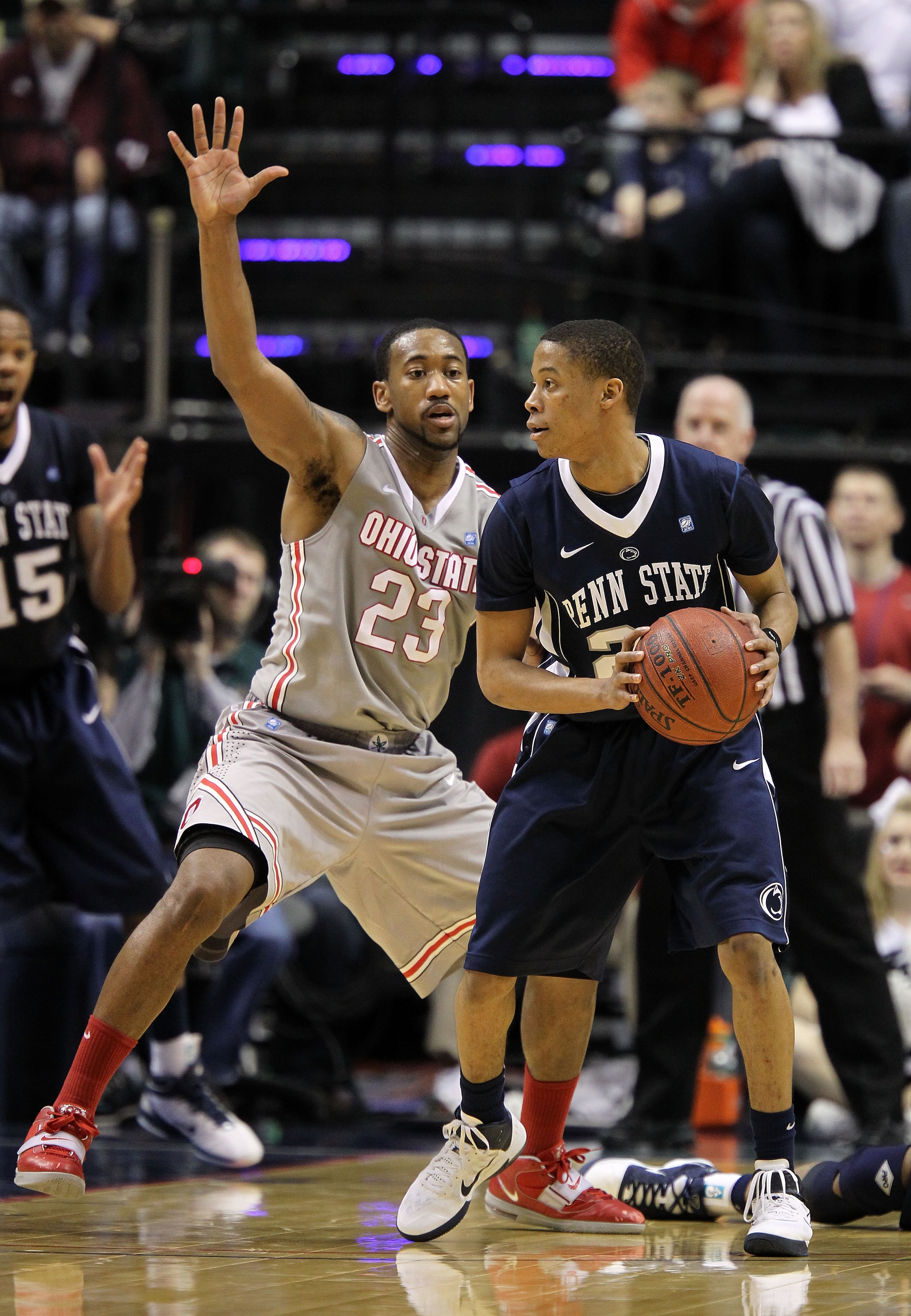 INDIANAPOLIS, IN - MARCH 13:  Tim Frazier #23 of the Penn State Nittany Lions looks to pass the ball against David Lighty #23 of the Ohio State Buckeyes during the championship game of the 2011 Big Ten Men's Basketball Tournament at Conseco Fieldhouse on