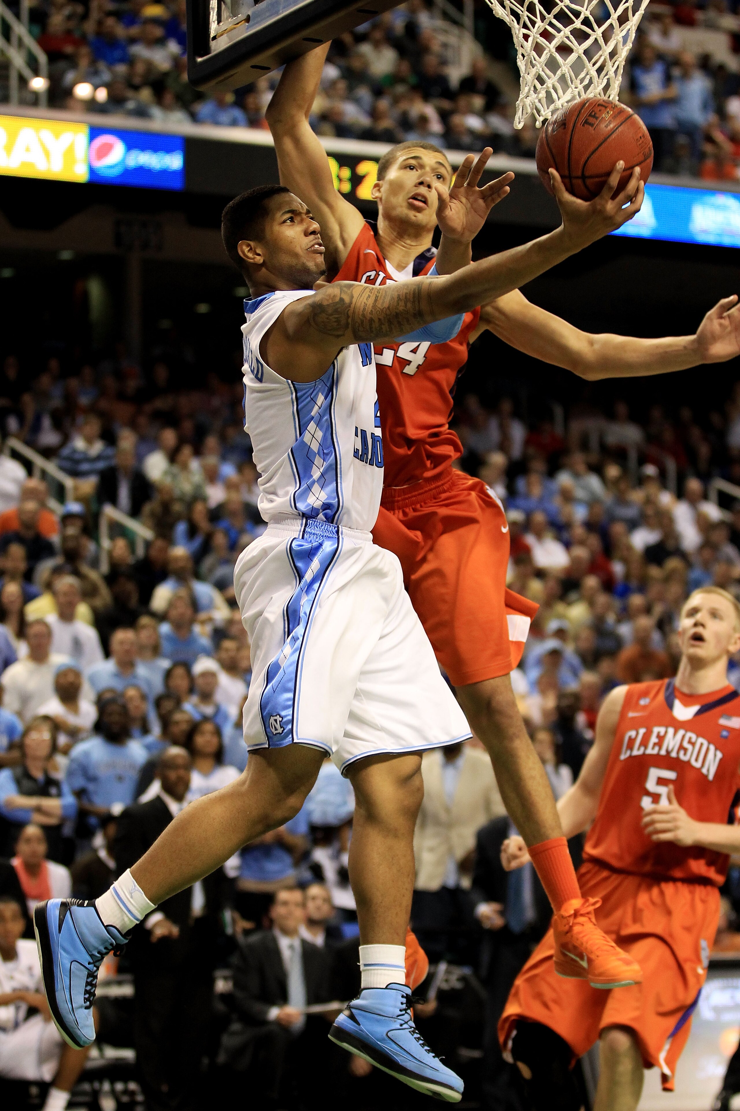 GREENSBORO, NC - MARCH 12:  Leslie McDonald #2 of the North Carolina Tar Heels shoots against Milton Jennings #24 of the Clemson Tigers during overtime in the semifinals of the 2011 ACC men's basketball tournament at the Greensboro Coliseum on March 12, 2