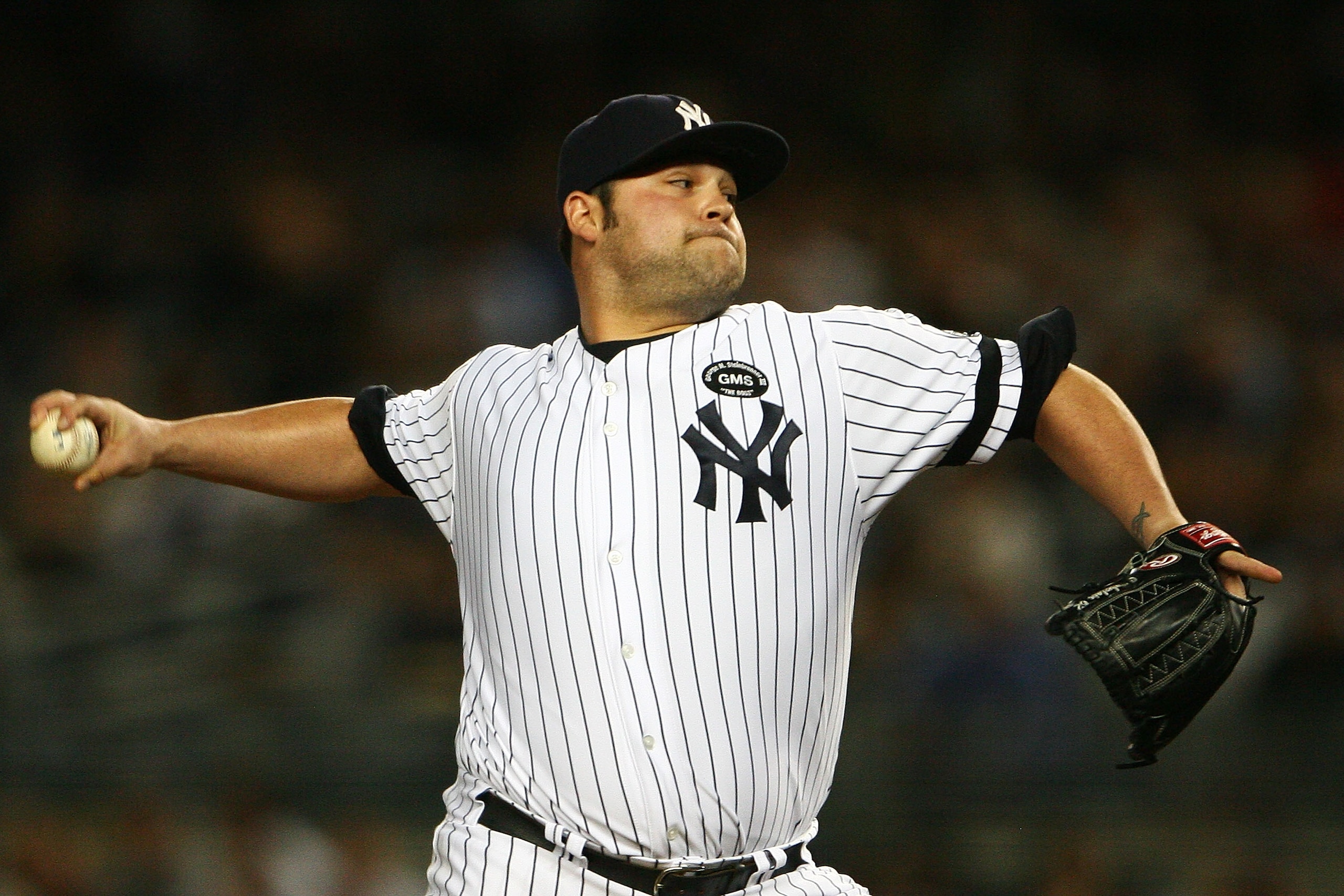 NEW YORK - SEPTEMBER 21:  Joba Chamberlain #62 of the New York Yankees pitches against the Tampa Bay Rays on September 21, 2010 at Yankee Stadium in the Bronx borough of New York City. The Yankees defeated the Rays 8 - 3.  (Photo by Andrew Burton/Getty Im