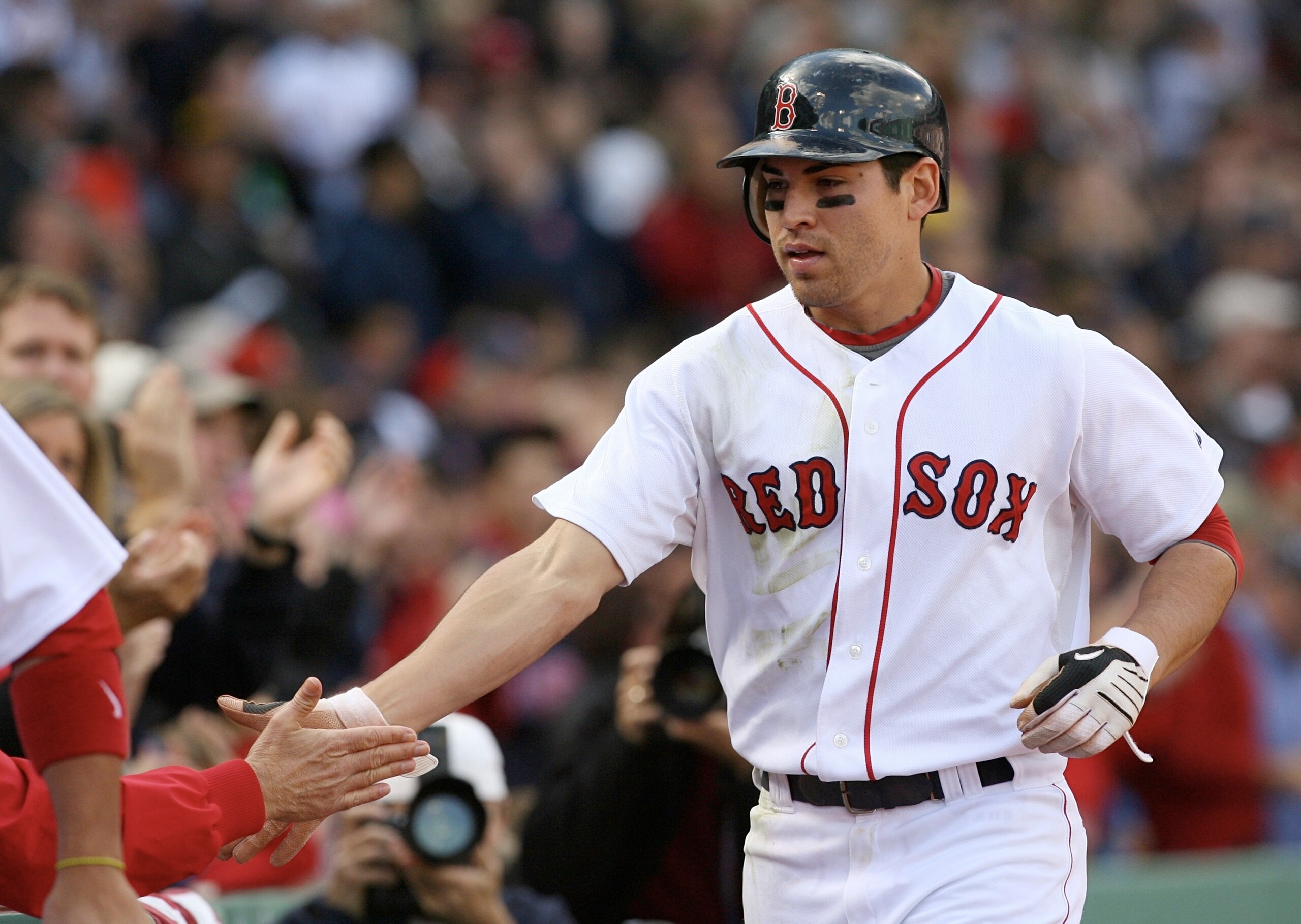 BOSTON - OCTOBER 11:  Jacoby Ellsbury #46 of the Boston Red Sox celebrates with teammates after scoring a run in the third inning against the Los Angeles Angels of Anaheim on a Dustin Pedroia #15 double in the third inning of Game Three of the ALDS during