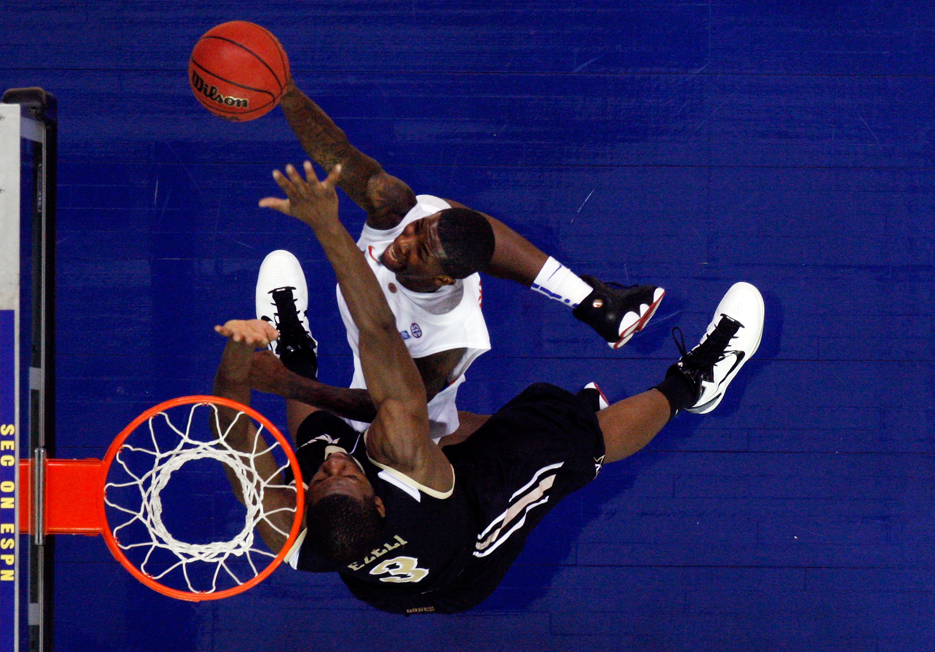 ATLANTA, GA - MARCH 12: Kenny Boynton #1 of the Florida Gators shoots against Festus Ezeli #3 of the Vanderbilt Commodores during the semifinals of the SEC Men's Basketball Tournament at Georgia Dome on March 12, 2011 in Atlanta, Georgia. (Photo by Kevi