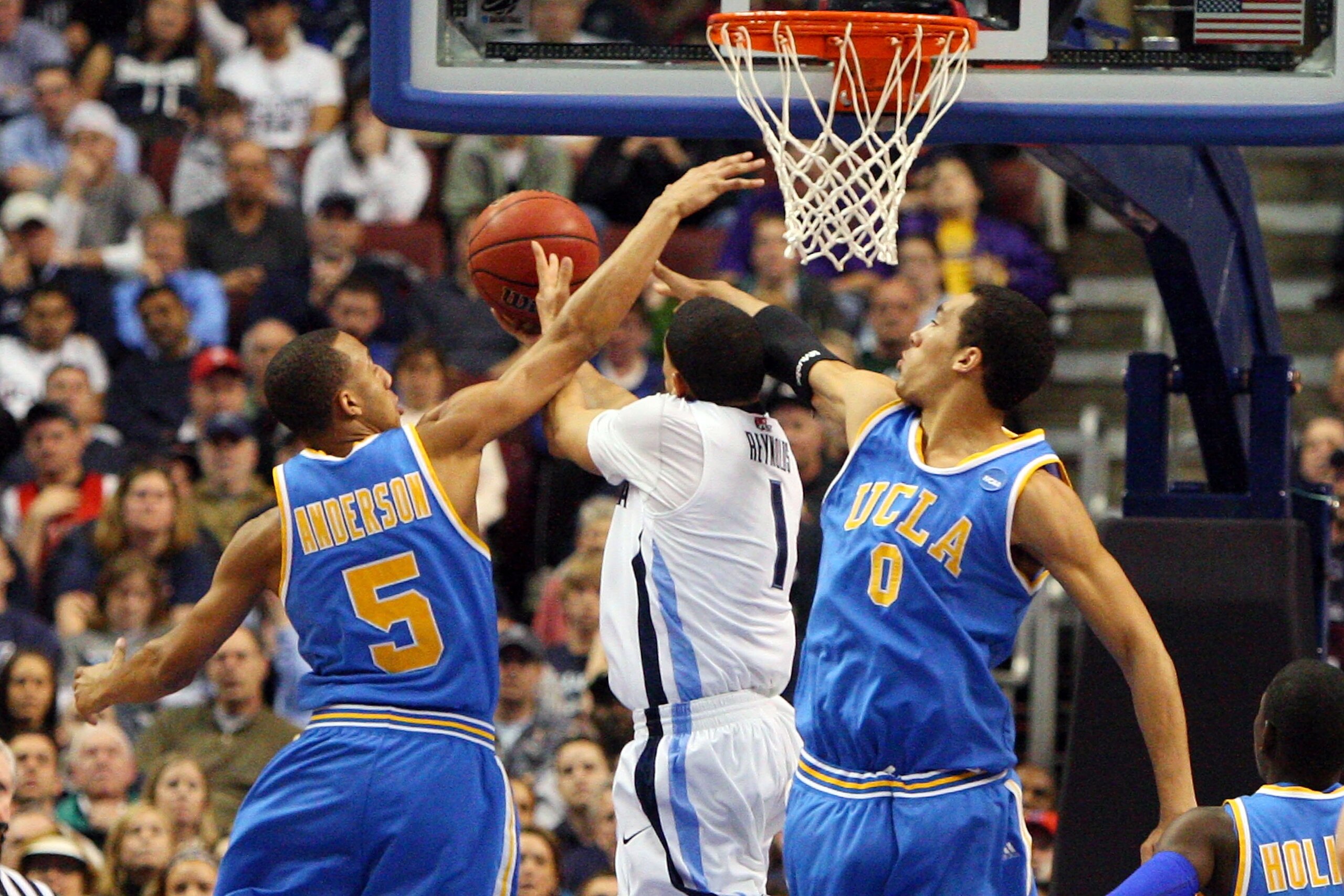 PHILADELPHIA - MARCH 21: Scottie Reynolds #1 of the Villanova Wildcats shoots against Jerime Anderson #5 and Drew Gordon #0 of the UCLA Bruins during the second round of the NCAA Division I Men's Basketball Tournament at the Wachovia Center on March 21, PHILADELPHIA - MARCH 21: Scottie Reynolds #1 of the Villanova Wildcats shoots against Jerime Anderson #5 and Drew Gordon #0 of the UCLA Bruins during the second round of the NCAA Division I Men's Basketball Tournament at the Wachovia Center on March 21,