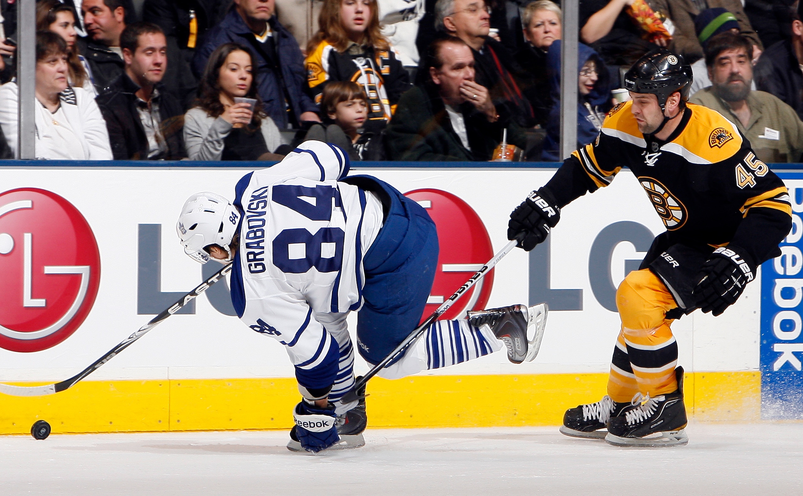 TORONTO, CANADA - DECEMBER 4: Mikhail Grabovski #84 of the Toronto Maple Leafs gets tripped by Mark Stuart #45 of the Boston Bruins during game action at the Air Canada Centre December 4, 2010 in Toronto, Ontario, Canada. (Photo by Abelimages / Getty Imag TORONTO, CANADA - DECEMBER 4: Mikhail Grabovski #84 of the Toronto Maple Leafs gets tripped by Mark Stuart #45 of the Boston Bruins during game action at the Air Canada Centre December 4, 2010 in Toronto, Ontario, Canada. (Photo by Abelimages / Getty Imag