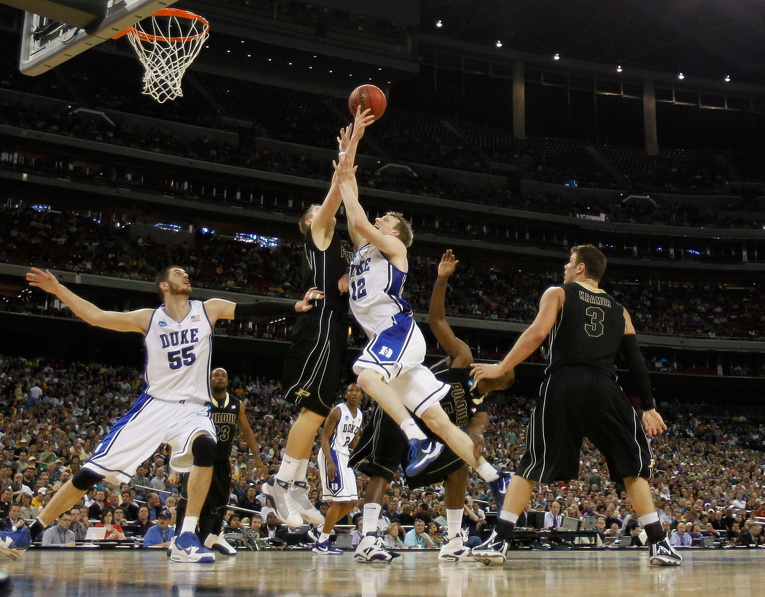 HOUSTON - MARCH 26: Patrick Bade #41 of the Purdue Boilermakers blocks a shot by Kyle Singler #12 of the Duke Blue Devils as Brian Zoubek #55 and Chris Kramer #3 watch during the south regional semifinal of the 2010 NCAA men's basketball tournament at Rel