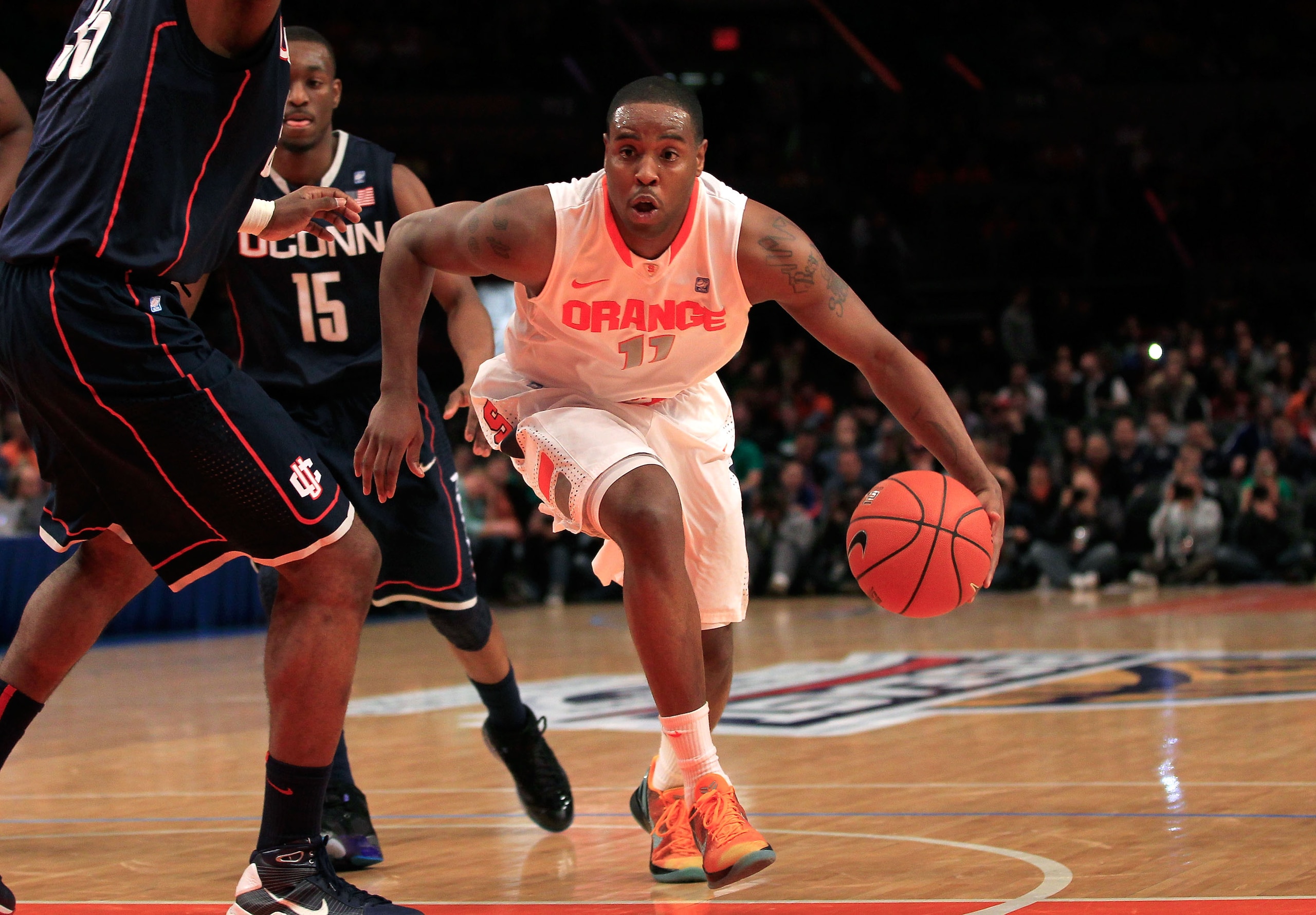 NEW YORK, NY - MARCH 11: Scoop Jardine #11 of the Syracuse Orange handles the ball agaisnt the Connecticut Huskies during the semifinals of the 2011 Big East Men's Basketball Tournament presented by American Eagle Outfitters at Madison Square Garden on Ma