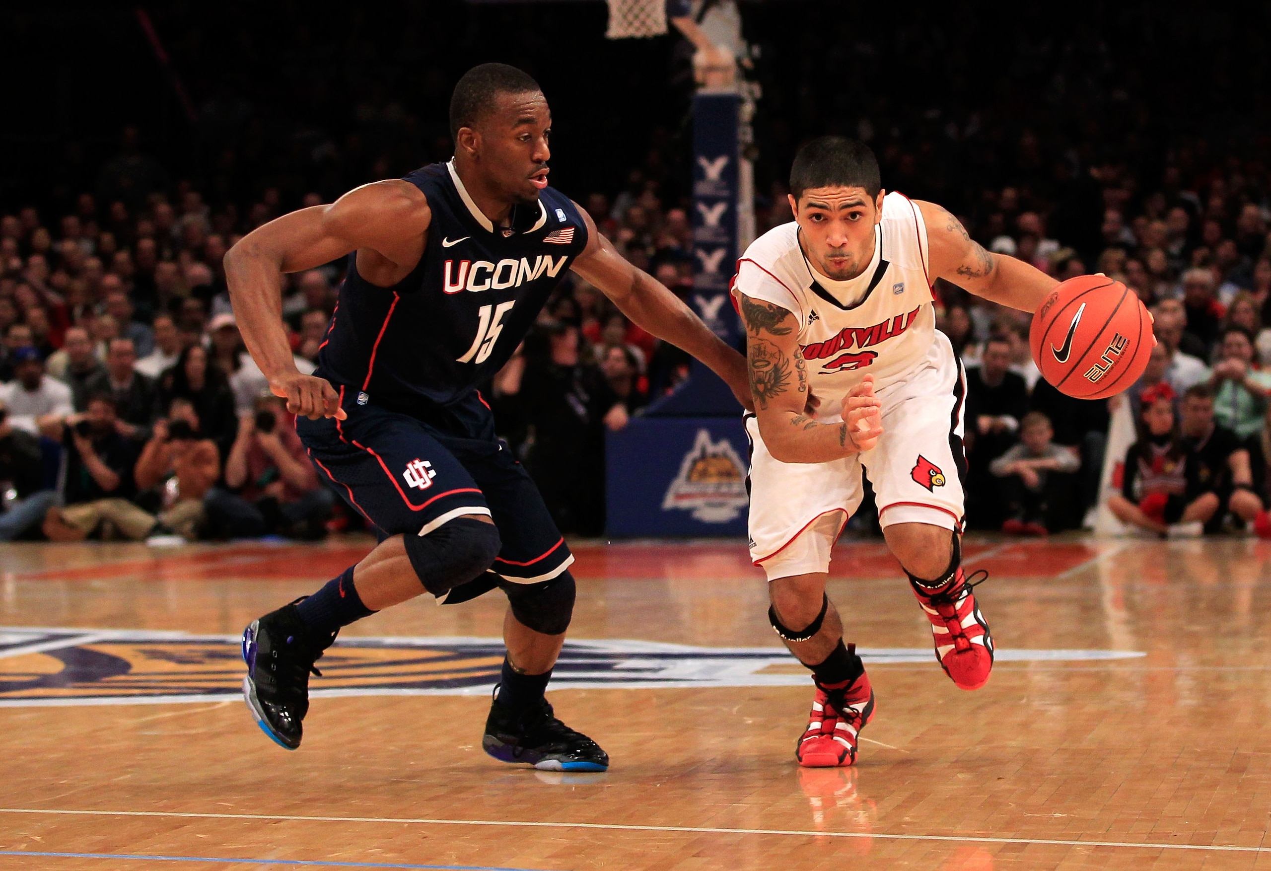 NEW YORK, NY - MARCH 12: Peyton Siva #3 of the Louisville Cardinals drives with the ball against Kemba Walker #15 of the Connecticut Huskies during the championship of the 2011 Big East Men's Basketball Tournament presented by American Eagle Outfitters at