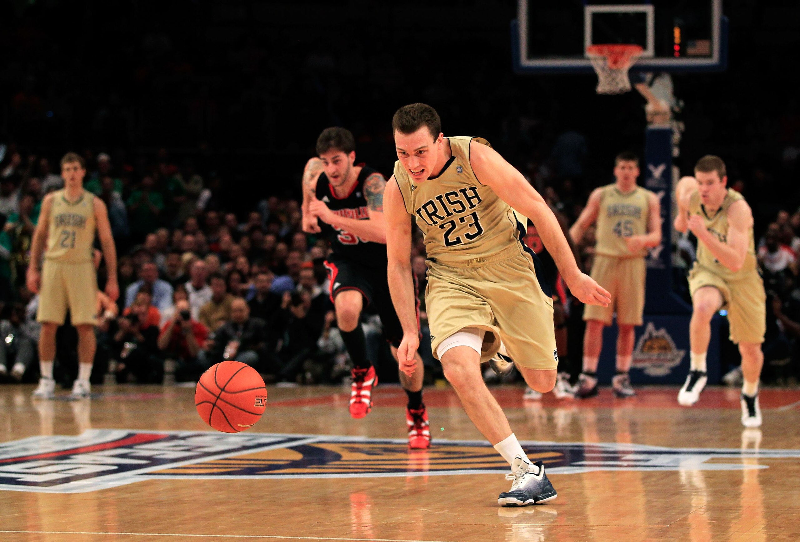 NEW YORK, NY - MARCH 11: Ben Hansbrough #23 of the Notre Dame Fighting Irish runs down a loose ball against the Louisville Cardinals during the semifinals of the 2011 Big East Men's Basketball Tournament presented by American Eagle Outfitters at Madison S NEW YORK, NY - MARCH 11: Ben Hansbrough #23 of the Notre Dame Fighting Irish runs down a loose ball against the Louisville Cardinals during the semifinals of the 2011 Big East Men's Basketball Tournament presented by American Eagle Outfitters at Madison S