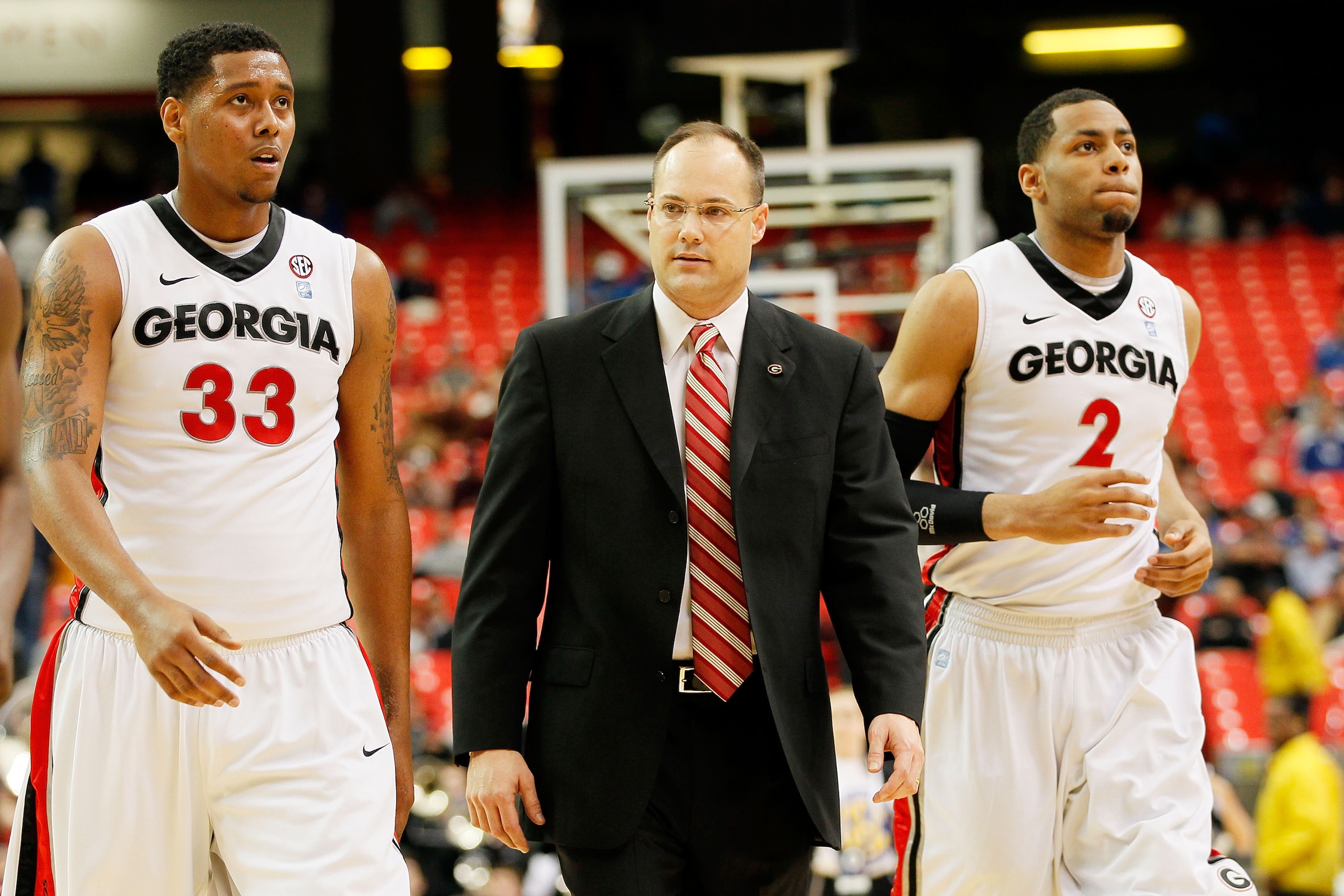 ATLANTA, GA - MARCH 10:  Head coach Mark Fox of the Georgia Bulldogs walks with Trey Thompkins #33 and Marcus Thornton #2 during their game against the Auburn Tigers during the first round of the SEC Men's Basketball Tournament at the Georgia Dome on Marc