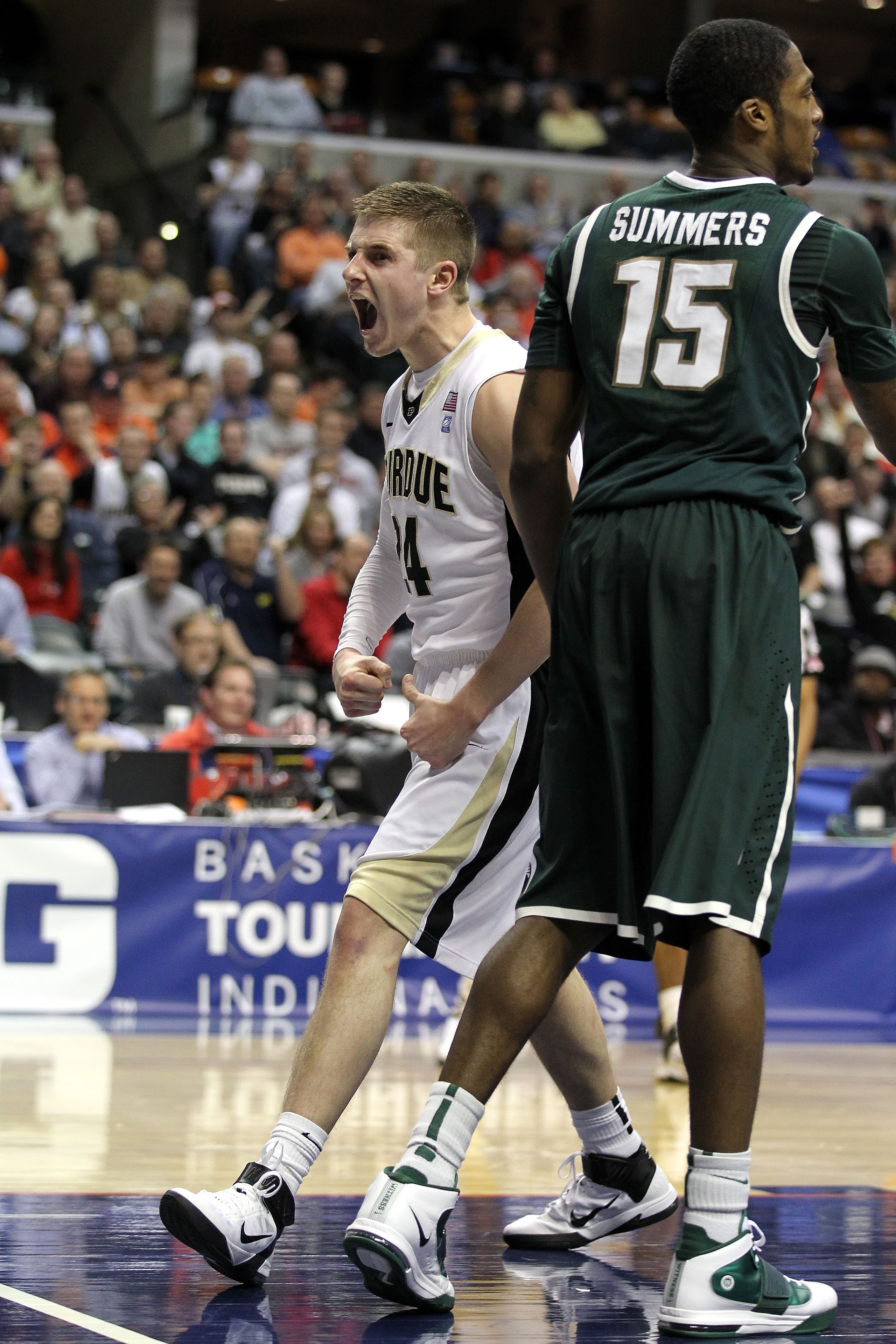INDIANAPOLIS, IN - MARCH 11:  Ryne Smith #24 of the Purdue Boilermakers reacts against Durrell Summers #15 of the Michigan State Spartans during the quarterfinals of the 2011 Big Ten Men's Basketball Tournament at Conseco Fieldhouse on March 11, 2011 in I