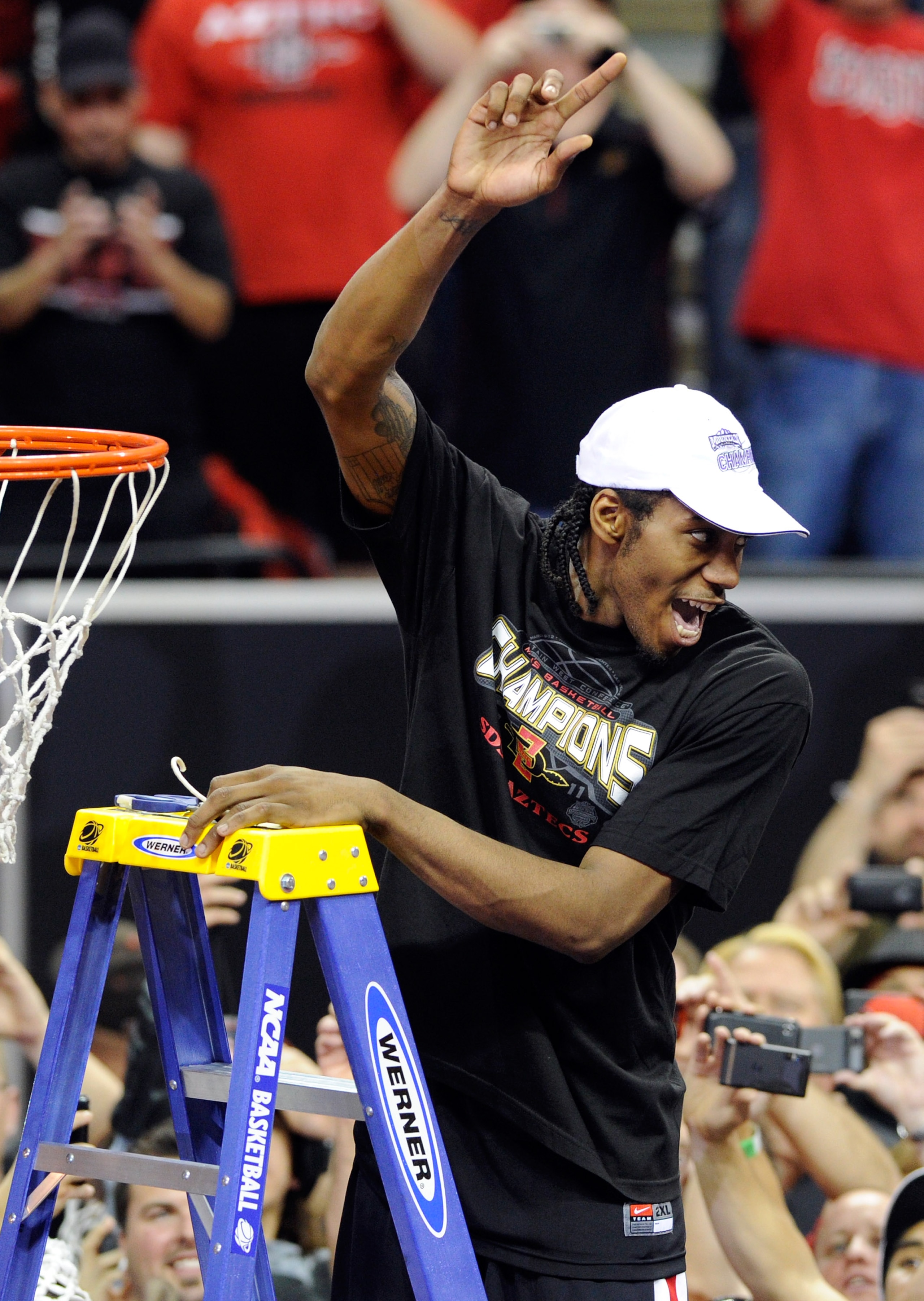 LAS VEGAS, NV - MARCH 12:  Kawhi Leonard #15 of the San Diego State Aztecs celebrates as he cuts a net after the team's 72-54 victory over the Brigham Young University Cougars in the championship game of the Conoco Mountain West Conference Basketball tour