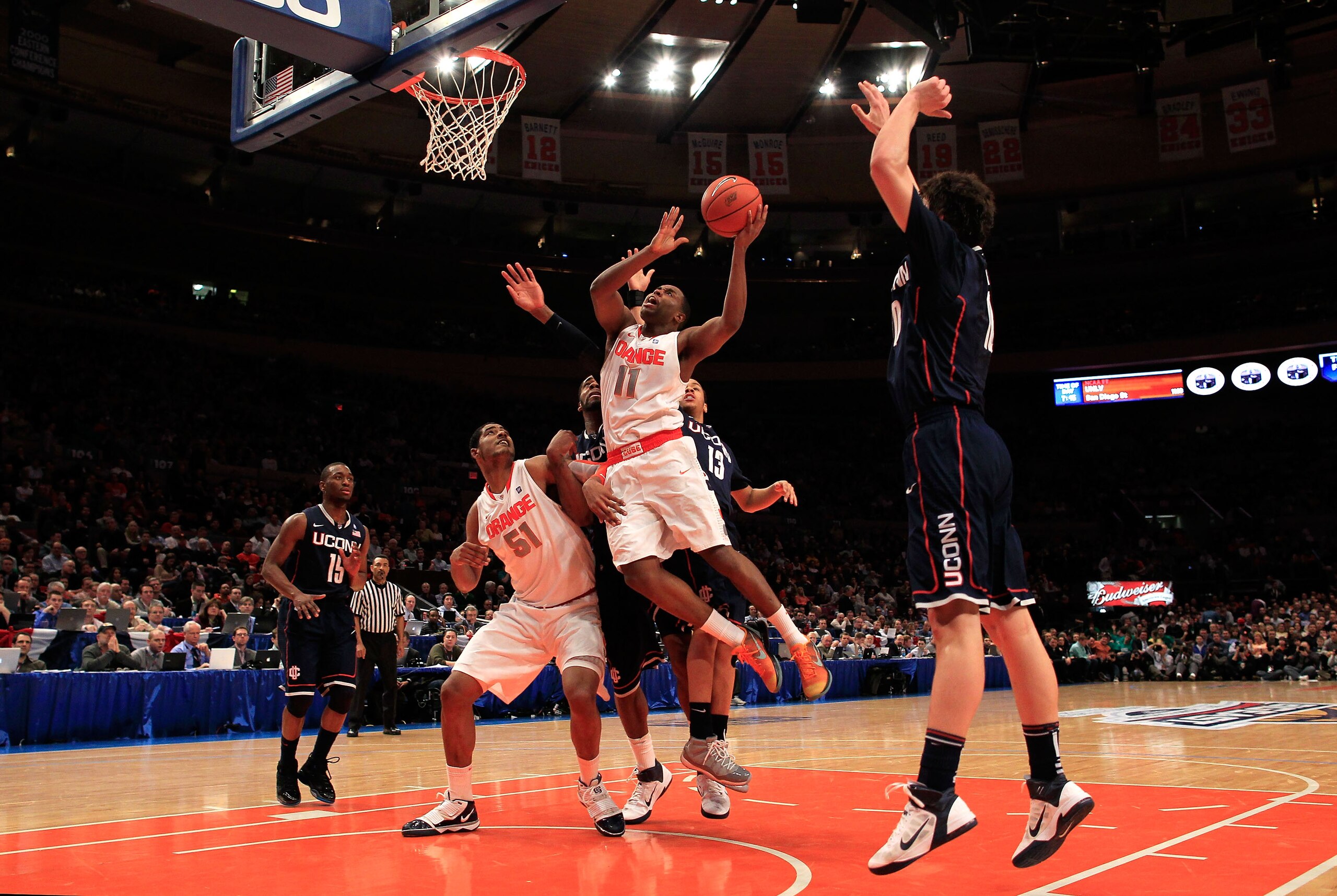 NEW YORK, NY - MARCH 11: Scoop Jardine #11 of the Syracuse Orange drives to the basket against the Connecticut Huskies during the semifinals of the 2011 Big East Men's Basketball Tournament presented by American Eagle Outfitters at Madison Square Garden o