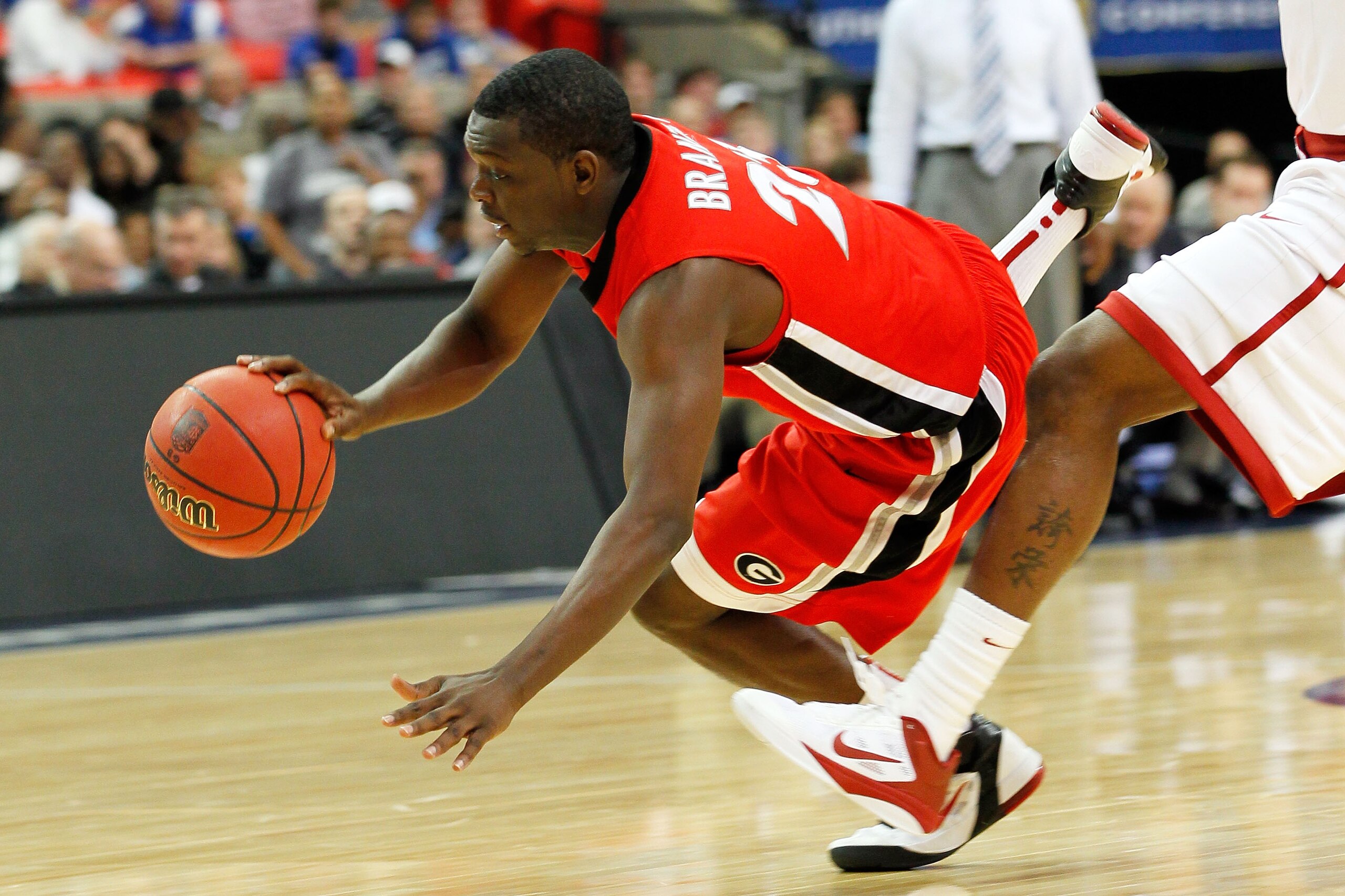 ATLANTA, GA - MARCH 11: Sherrard Brantley #23 of the Georgia Bulldogs gets tripped up during their game against the Alabama Crimson Tide in the quarterfinals of the SEC Men's Basketball Tournament at Georgia Dome on March 11, 2011 in Atlanta, Georgia.  (P