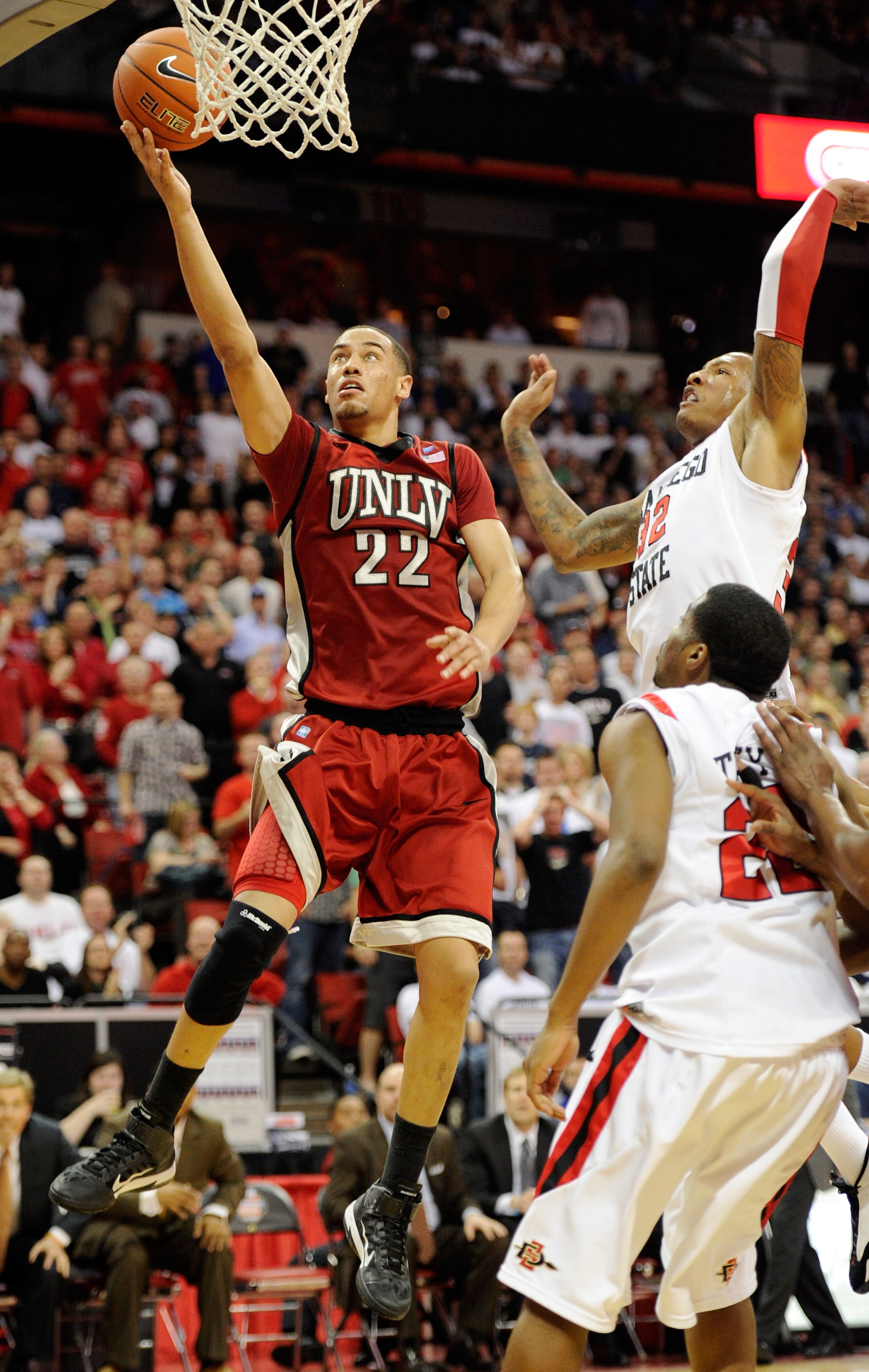 LAS VEGAS, NV - MARCH 11:  Chace Stanback #22 of the UNLV Rebels shoots against Billy White #32 and Chase Tapley #22 of the San Diego State Aztecs during a semifinal game of the Conoco Mountain West Conference Basketball tournament at the Thomas & Mack Ce