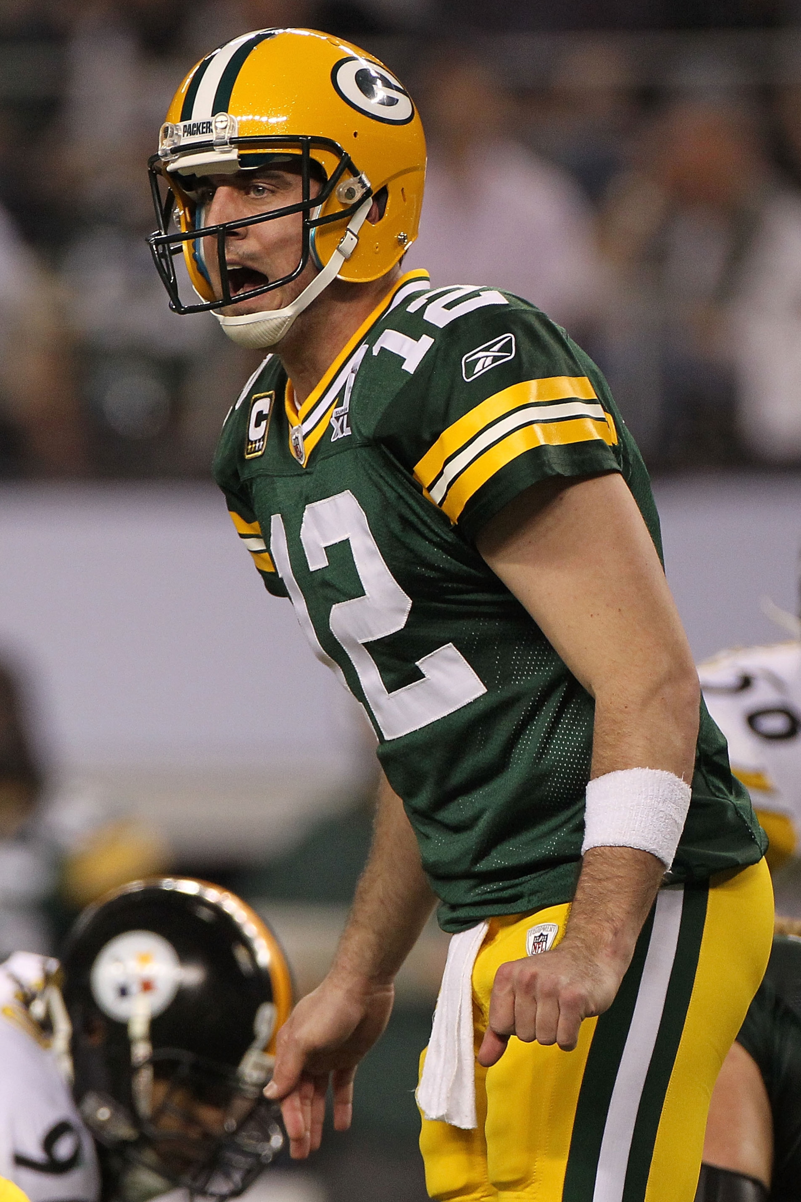 ARLINGTON, TX - FEBRUARY 06:  Quarterback Aaron Rodgers #12 of the Green Bay Packers calls out from under center while taking on the Pittsburgh Steelers during Super Bowl XLV at Cowboys Stadium on February 6, 2011 in Arlington, Texas.  (Photo by Doug Pens