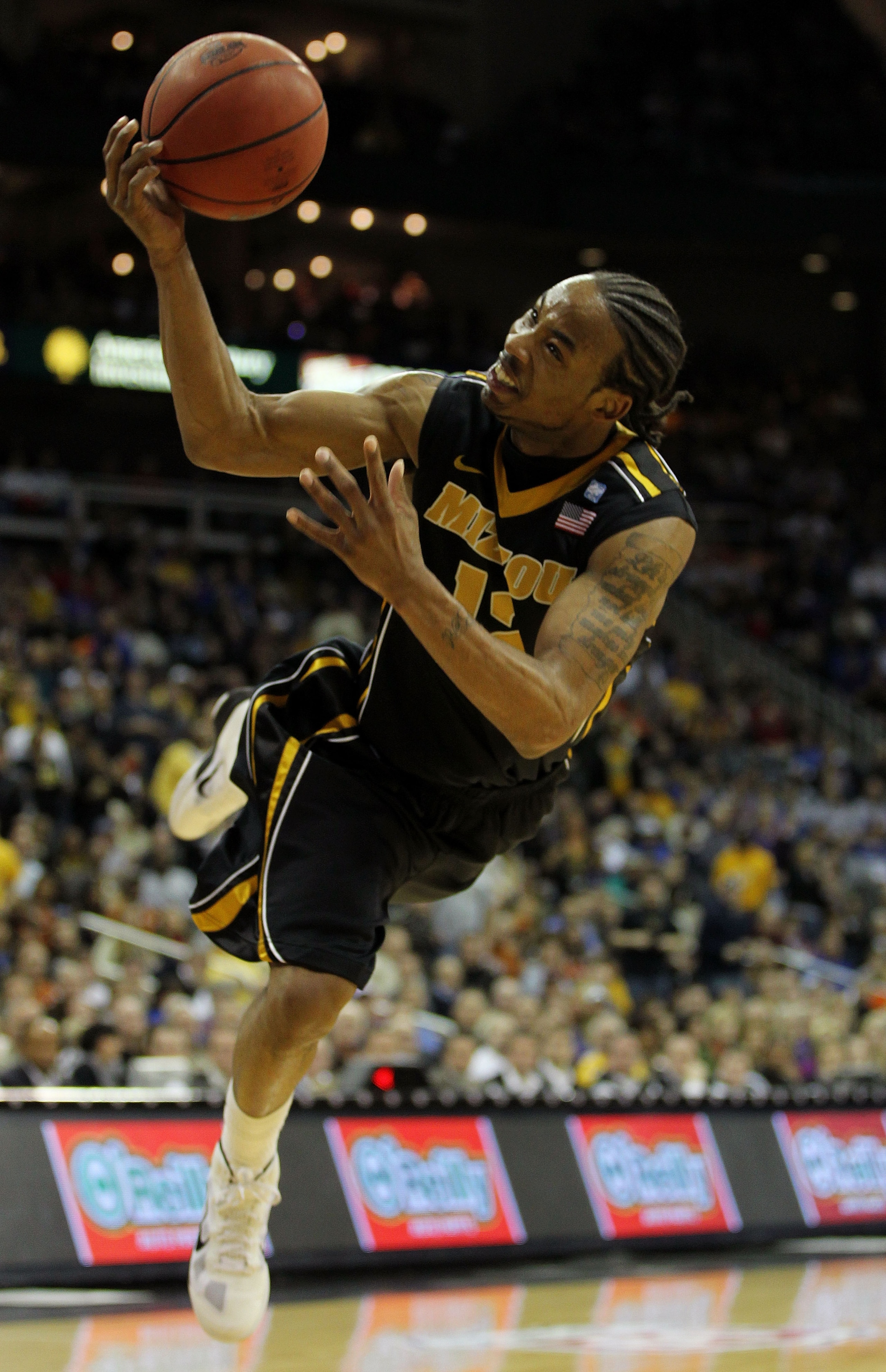 KANSAS CITY, MO - MARCH 10:  Marcus Denmon #12 of the Missouri Tigers throws a shot up against the Texas A&M Aggies during their quarterfinal game in the 2011 Phillips 66 Big 12 Men's Basketball Tournament at Sprint Center on March 10, 2011 in Kansas City