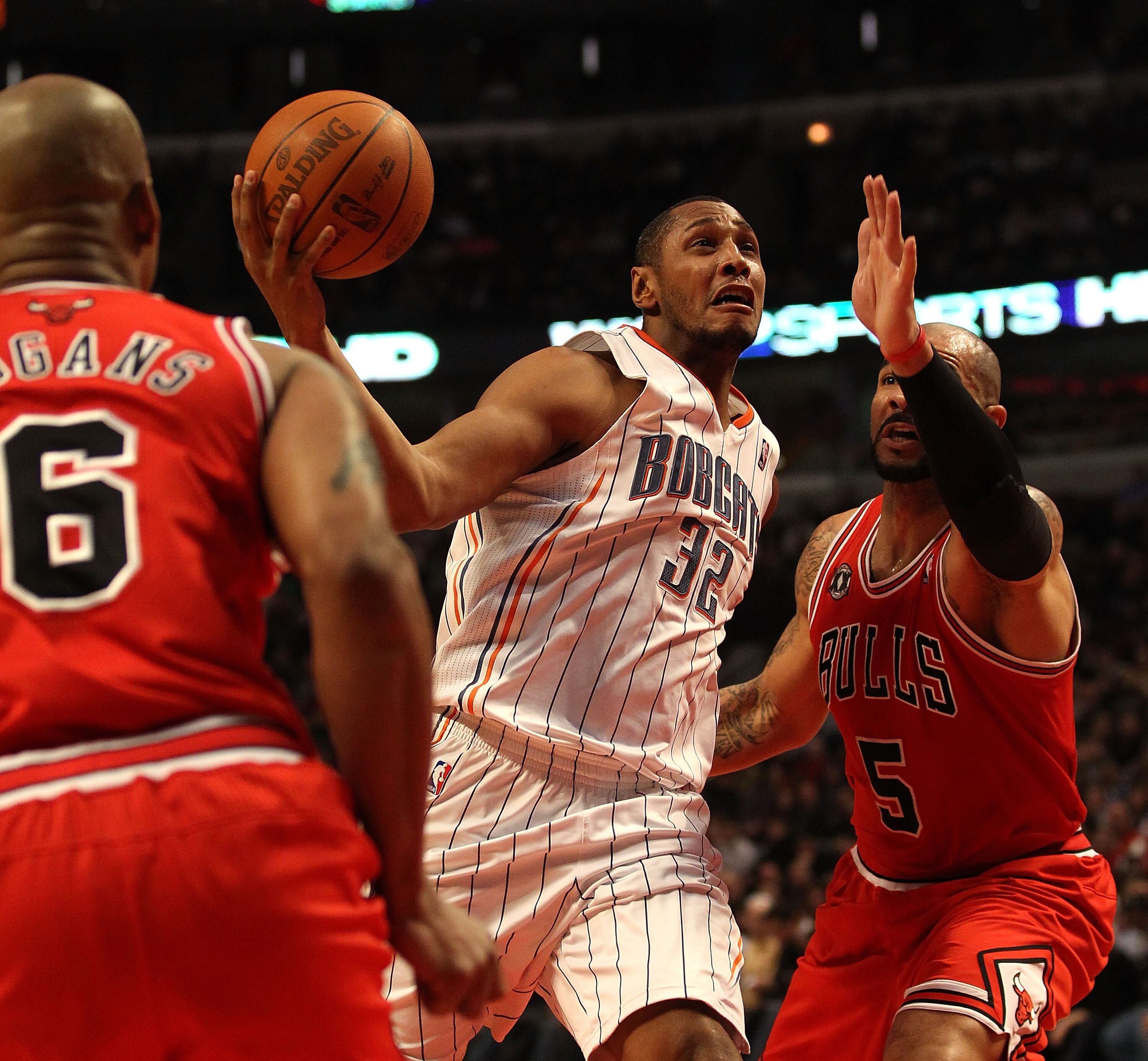 CHICAGO, IL - FEBRUARY 15: Boris Diaw #32 of the Charlotte Bobcats goes up for a shot between Carlos Boozer #5 and Keith Bogans #6 of the Chicago Bulls at the United Center on February 15, 2011 in Chicago, Illinois. The Bulls defeated the Bobcats 106-94.