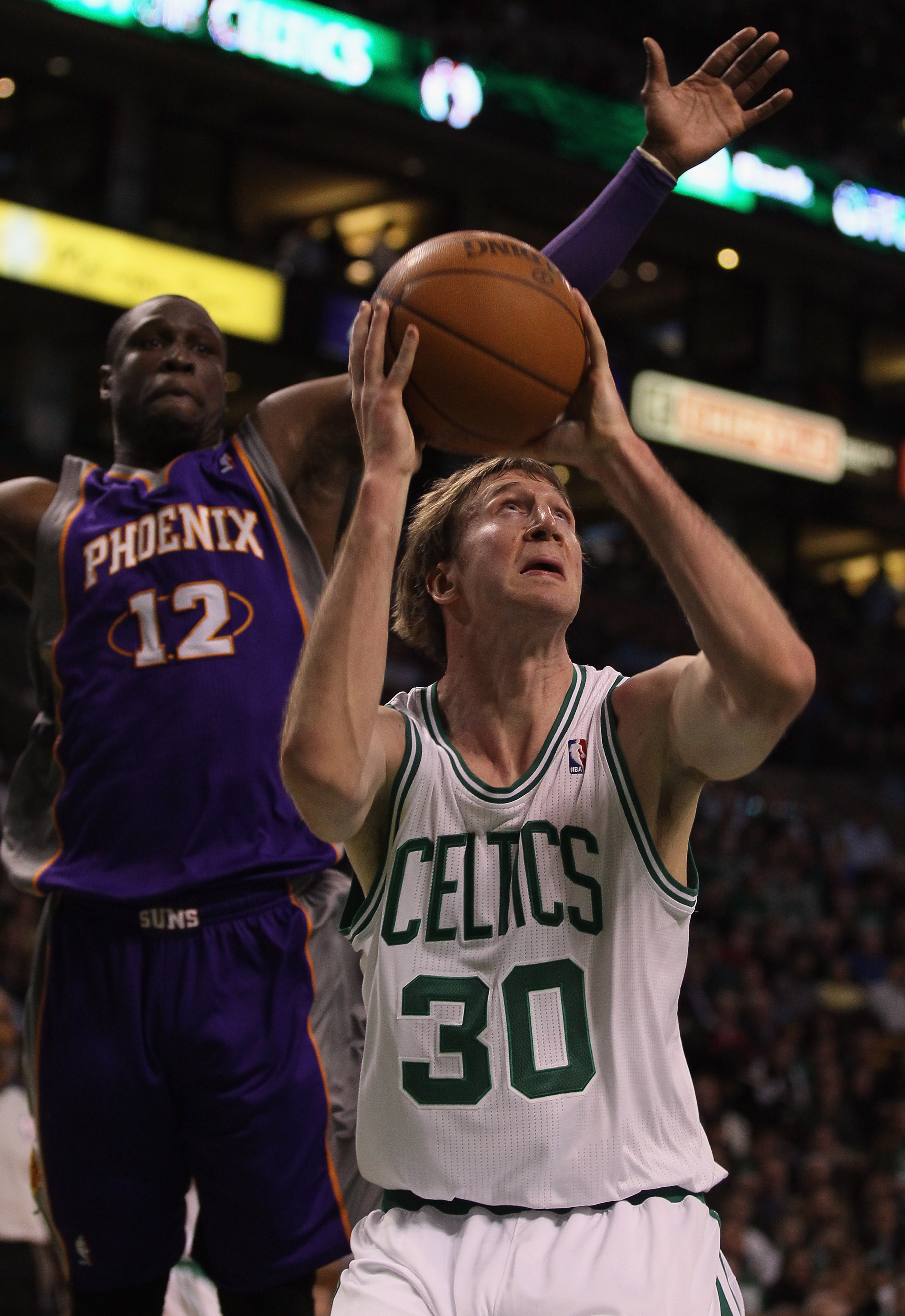 BOSTON, MA - MARCH 02:  Troy Murphy #30 of the Boston Celtics takes a shot as Mickael Pietrus #12 of the Phoenix Suns defends on March 2, 2011 at the TD Garden in Boston, Massachusetts.  NOTE TO USER: User expressly acknowledges and agrees that, by downlo
